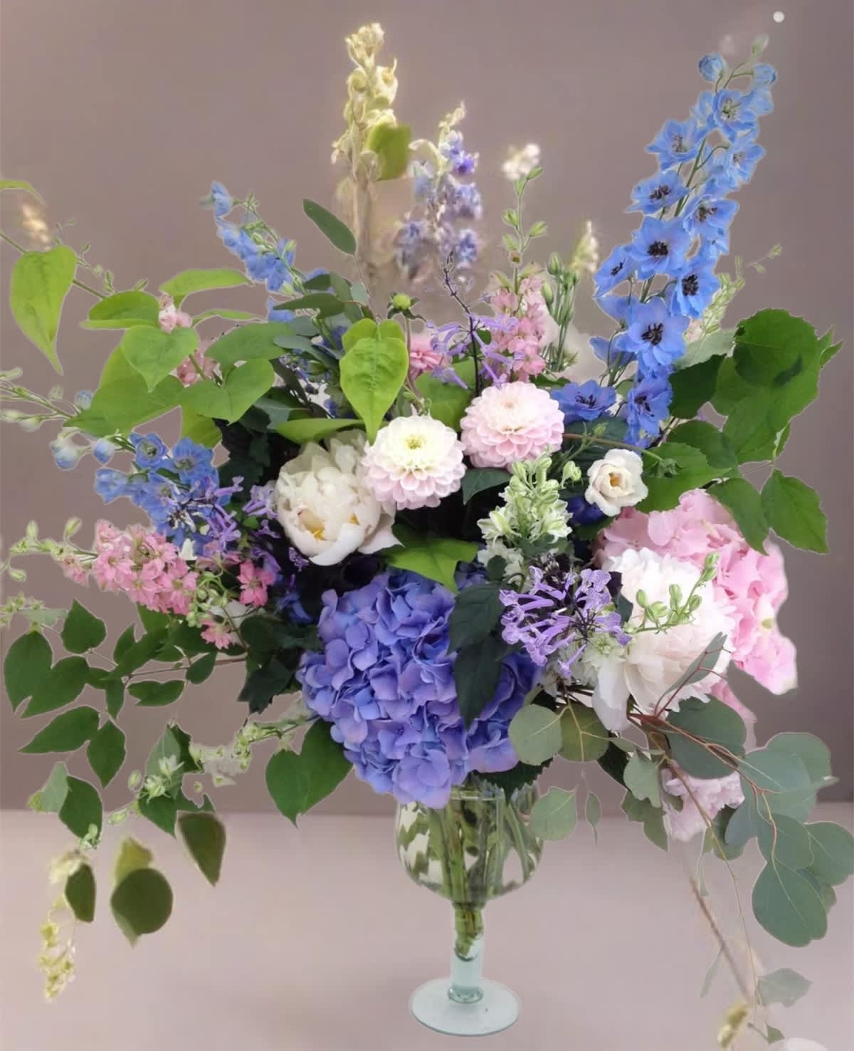 Mixed pastel flower arrangement in a clear glass vase