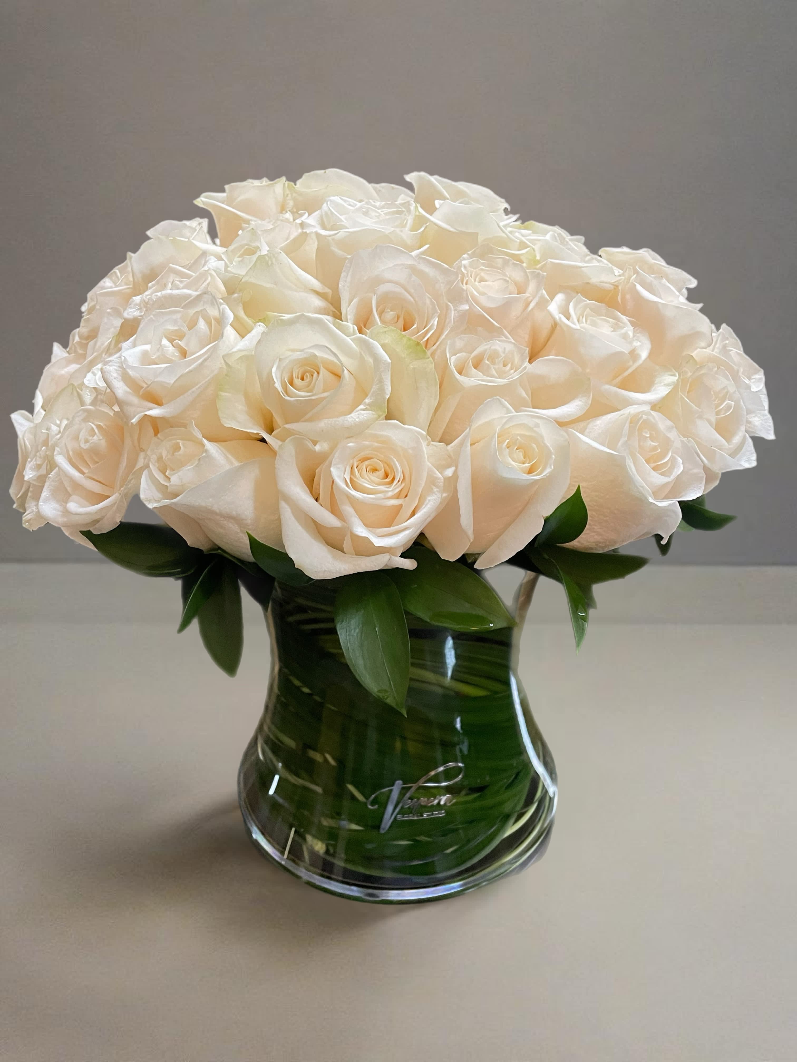White rose bouquet in a clear glass vase
