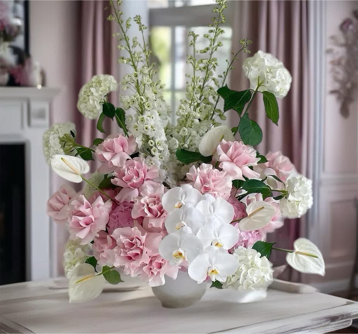 Pink and white floral arrangement in a white vase