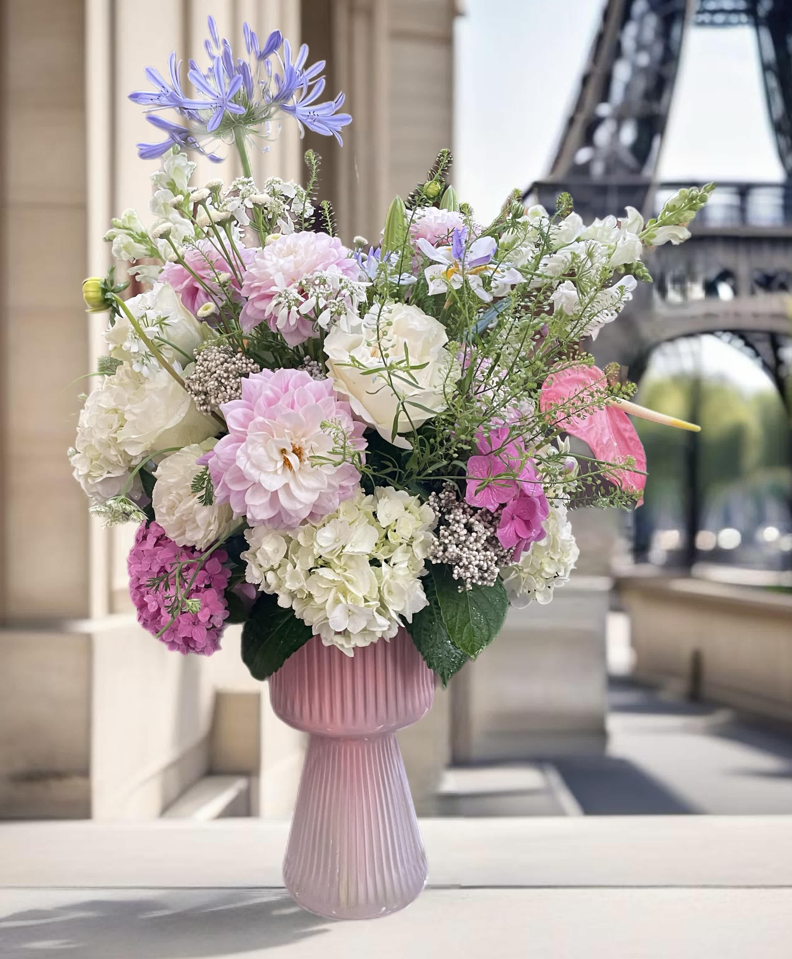 Pink and white floral arrangement in a ribbed vase