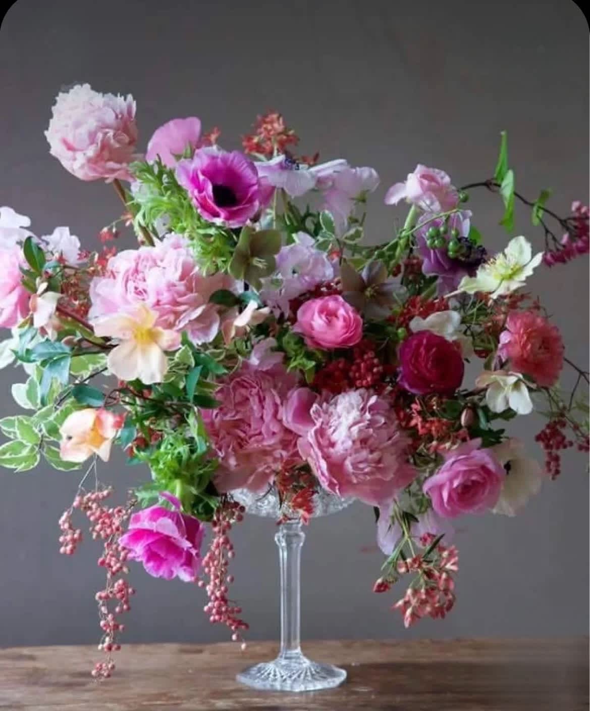 Large pink and white floral arrangement in a clear glass vase
