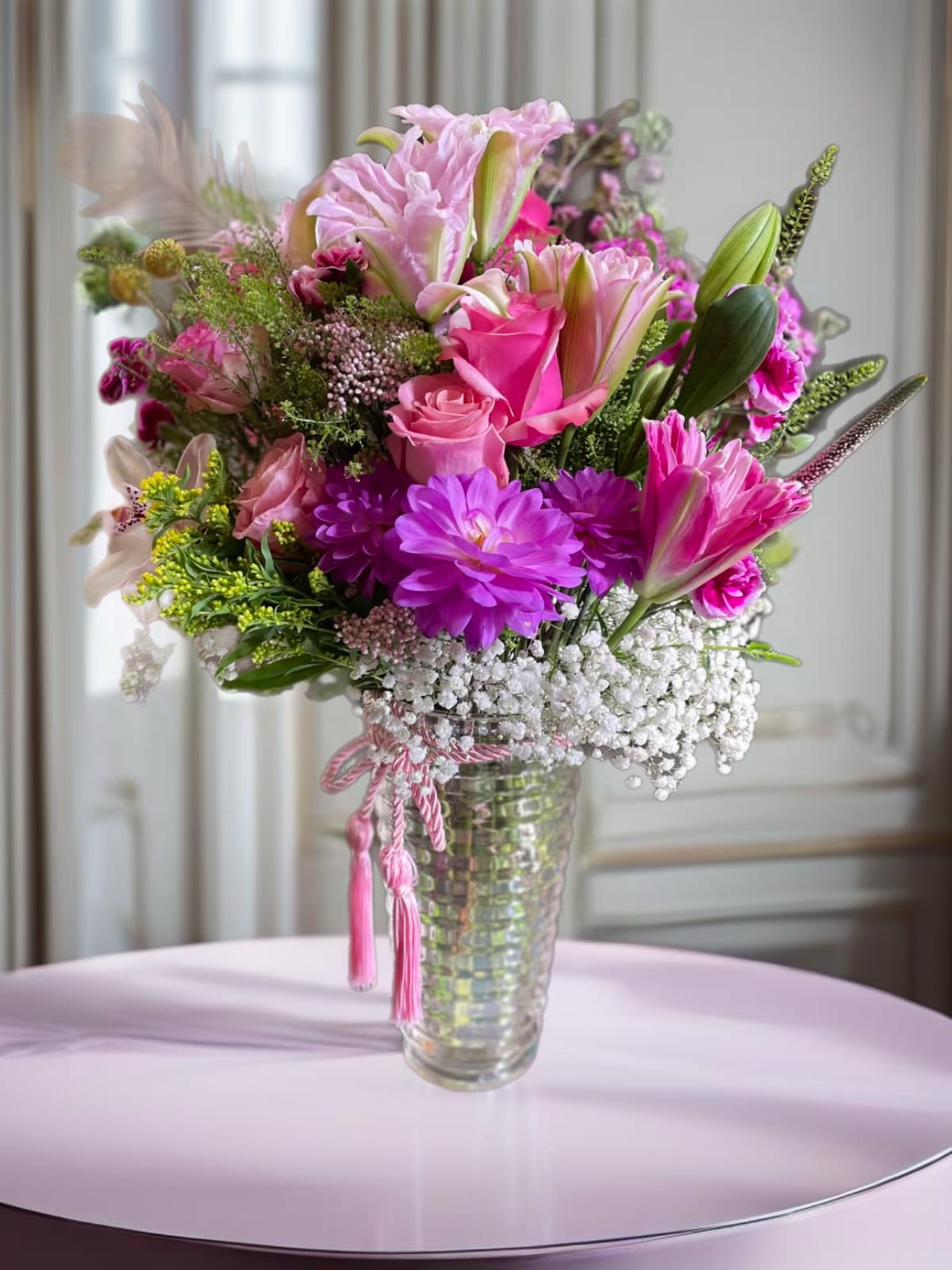 Pink and purple mixed bouquet in a clear glass vase