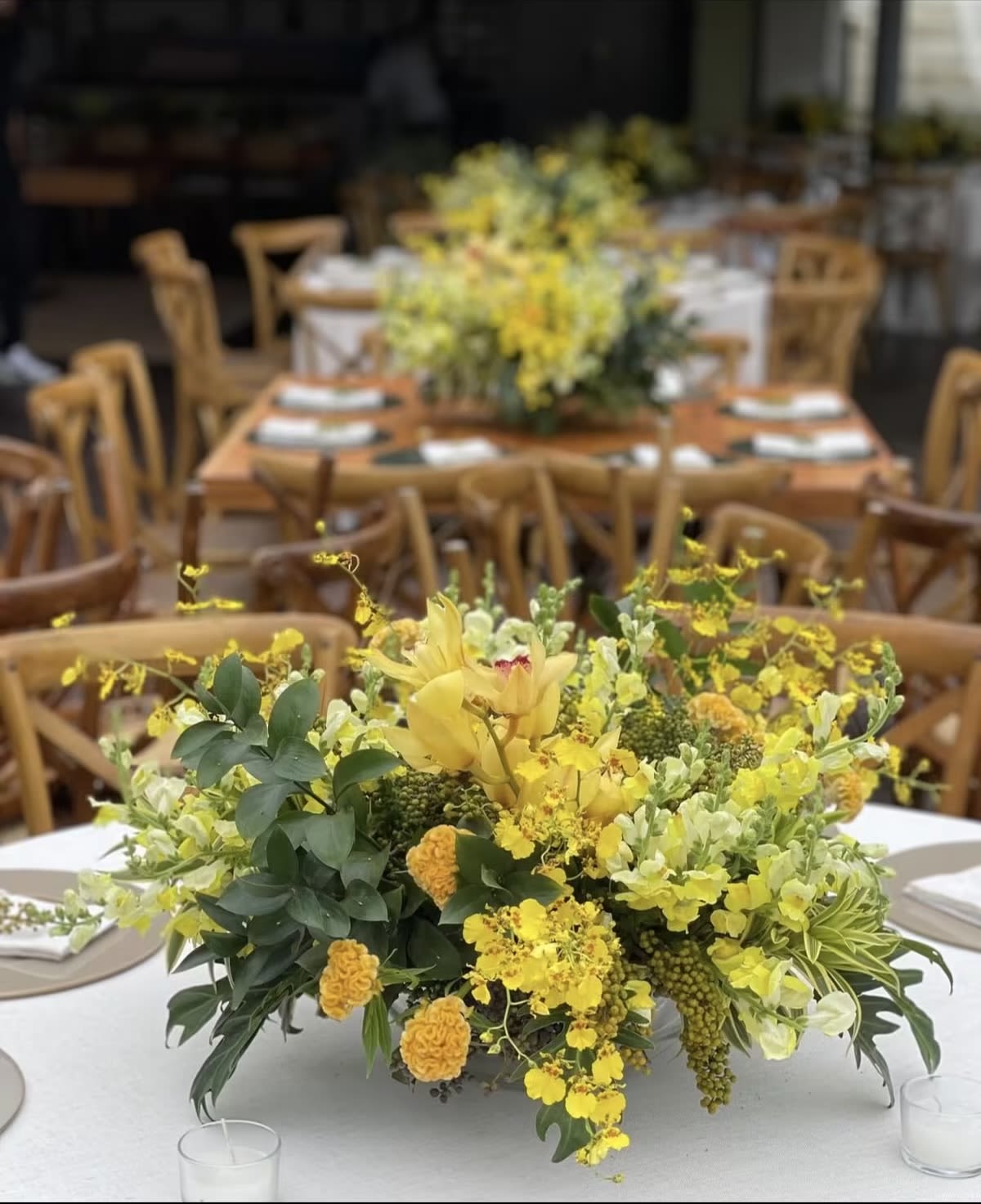 Yellow floral centerpiece on a round table