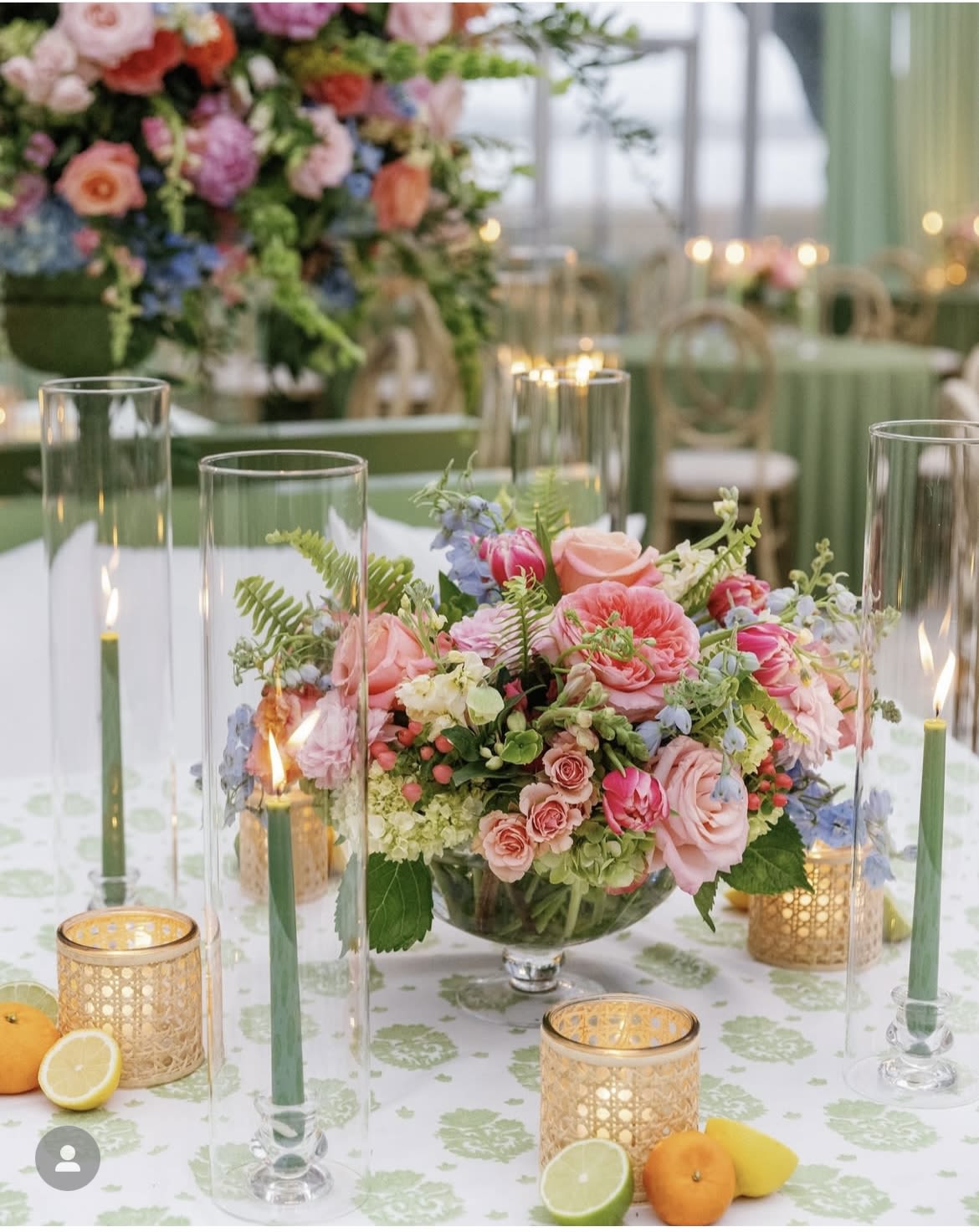 Low floral centerpiece with pink and peach roses in a glass bowl