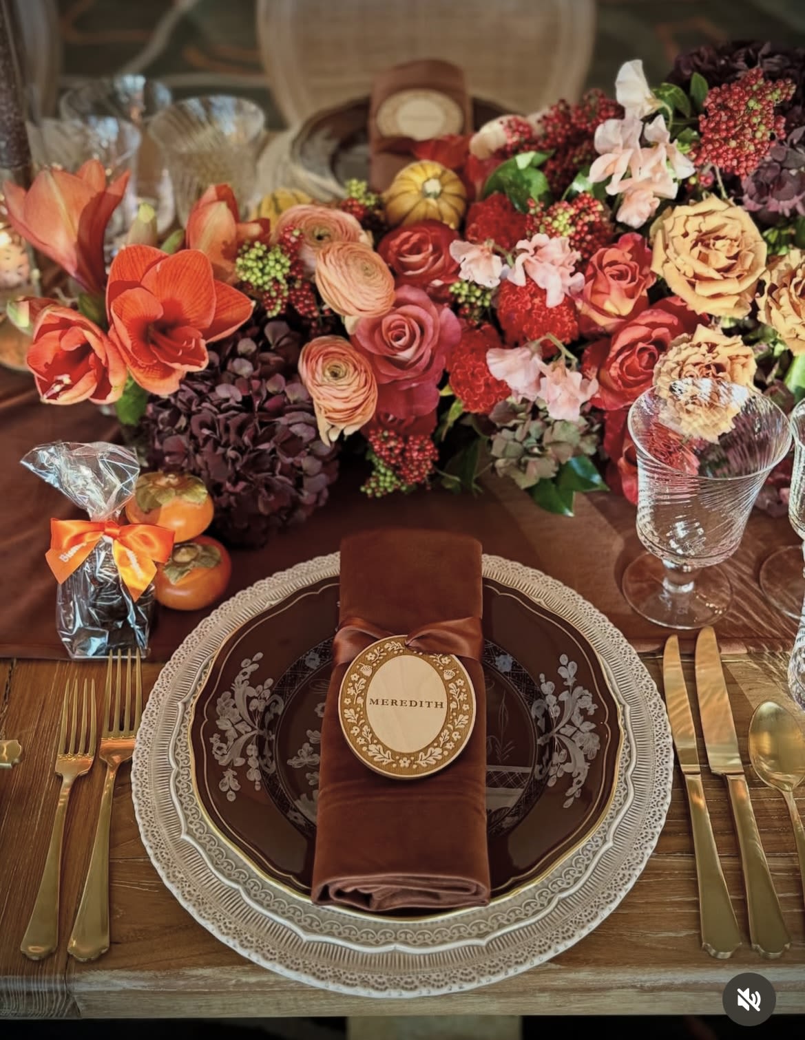 Autumn table setting with a large floral centerpiece and place settings
