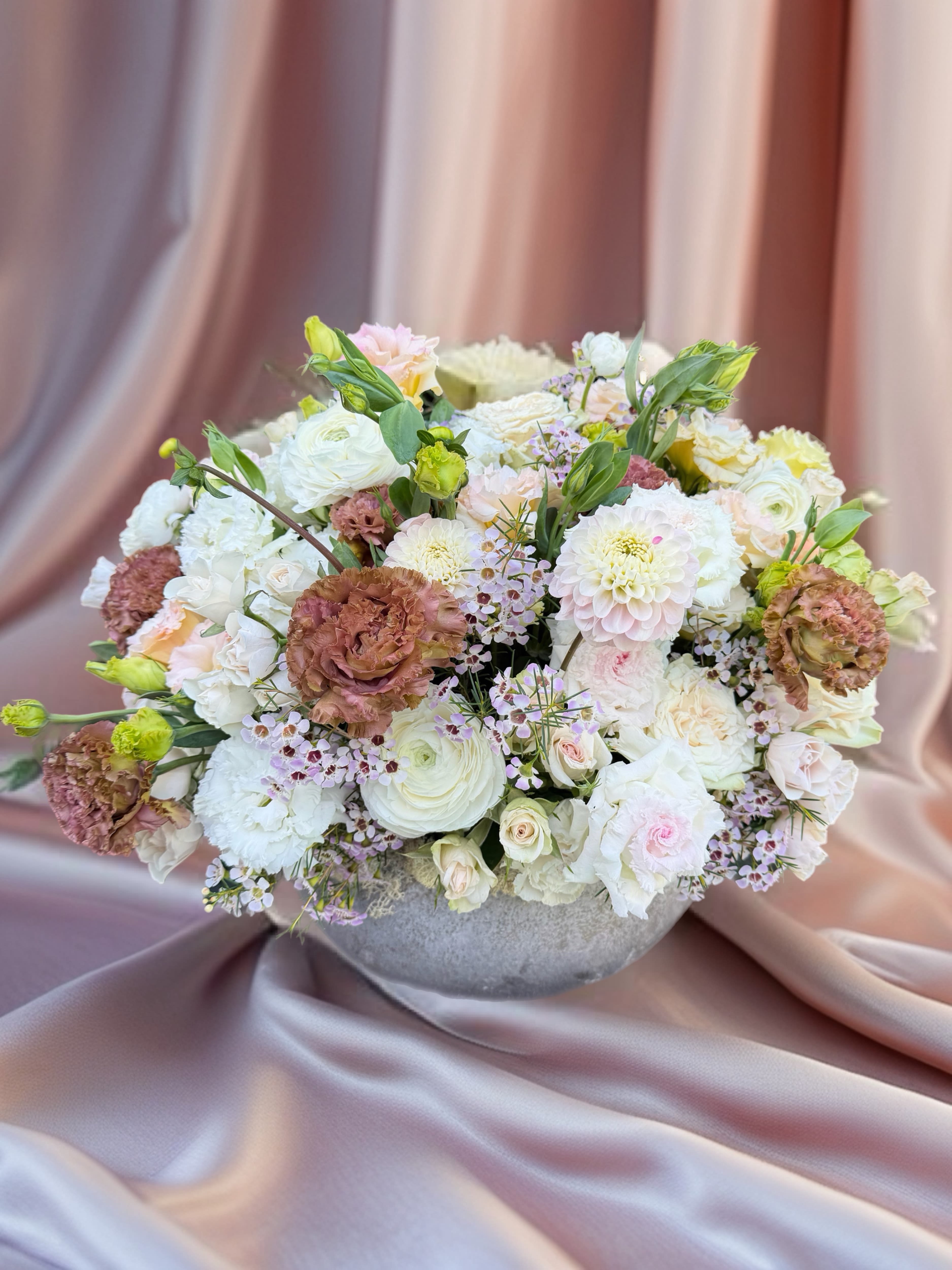 Large pastel bouquet in a gray bowl vase