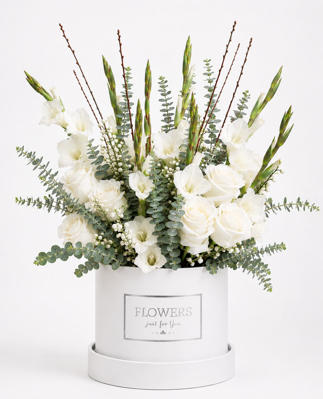 White roses and gladiolus in a white hatbox with eucalyptus