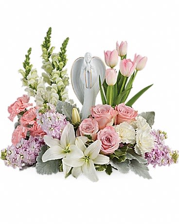 Pink and white floral arrangement with a silver angel figurine