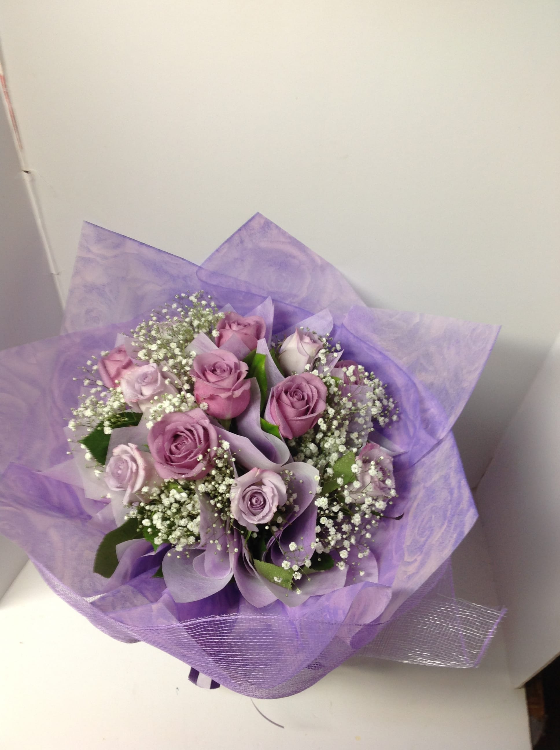 Lavender rose bouquet wrapped in purple paper