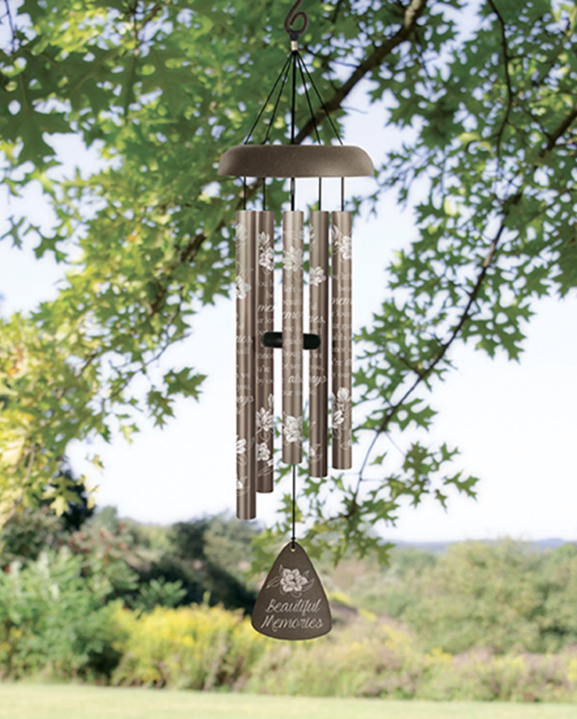 Beautiful Memories Windchime 30” 64695 - The Beautiful Memories wind chime is a meaningful keepsake gift designed to bring comfort, beauty, and peaceful sound to life’s most heartfelt moments. Featuring painted aluminum tubes with an elegant floral design, this decorative wind chime creates soft, soothing tones perfect for porches, patios, gardens, homes, memorial spaces, offices, or quiet places of reflection.  The Beautiful Memories sentiment makes this wind chime a thoughtful choice for remembrance gifts, sympathy gifts, birthdays, anniversaries, encouragement gifts, celebrations of life, holidays, friendship gifts, thank-you gifts, and everyday thinking-of-you moments. Its timeless design and calming melody create a lasting reminder of love, family, friendship, connection, and treasured memories.  Available boxed with ribbon, displayed on a temporary stand, or upgraded with a fresh flower spray for an elegant presentation, this versatile keepsake pairs beautifully with fresh flowers, green plants, lanterns, gourmet baskets, memorial stones, and other meaningful gifts. The bronze-toned finish complements traditional, rustic, garden-inspired, farmhouse, and contemporary décor beautifully indoors or outdoors.  Perfect for homes, services, memorial displays, patios, gardens, and thoughtful gifting, the Beautiful Memories wind chime combines lasting beauty, heartfelt sentiment, and peaceful melody in one timeless keepsake designed to be cherished for years to come.