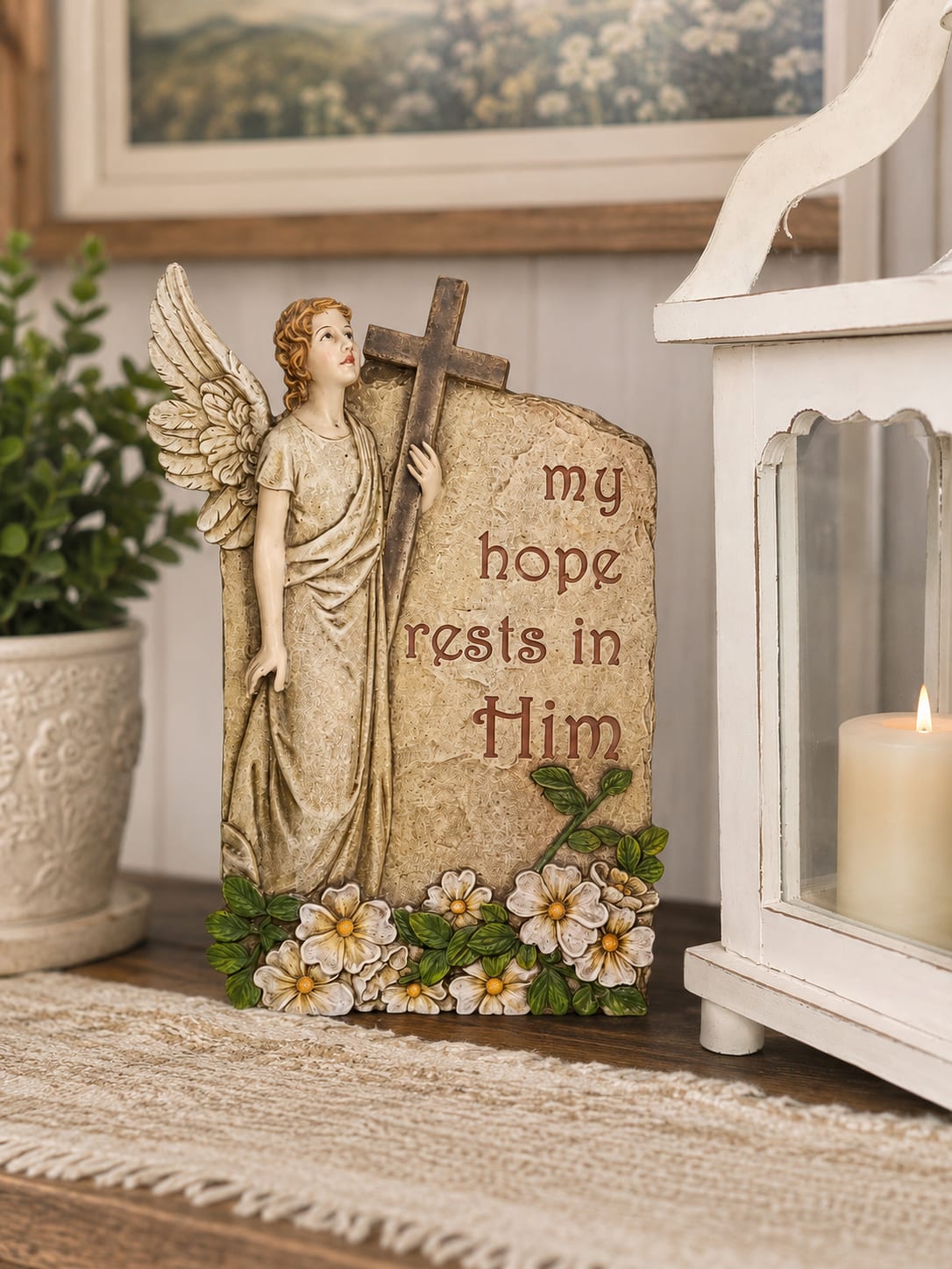 My Hope Rests In Him Plaque - Featuring a graceful angel, cross, and the inspirational message “My Hope Rests in Him,” this beautifully detailed molded resin plaque serves as a lasting reminder of faith, comfort, hope, and God’s promises. Its timeless design makes it a meaningful gift for encouragement, sympathy, bereavement, thinking of you occasions, memorial remembrance, church members, caregivers, friends, and loved ones facing life’s difficult seasons.  Available in Standard, Deluxe, and Premium presentations, allowing you to choose the option that best fits your occasion. The Standard version includes the plaque accented with a coordinating ribbon. The Deluxe version is presented within a fresh floral arrangement designed to complement the plaque’s colors and message. The Premium version features a larger, more abundant floral display for greater visual impact and presentation.  Perfect for homes, churches, funeral services, celebration of life gatherings, care facilities, offices, prayer rooms, and faith-based gifting. The angel imagery and uplifting sentiment provide comfort long after flowers have faded, creating a keepsake that can be displayed year-round.  Plaque measures approximately 8–9 inches tall. Floral varieties and ribbon styles may vary based on seasonal availability, but the overall appearance, value, and presentation will be maintained. A thoughtful expression of faith, comfort, encouragement, and lasting remembrance.