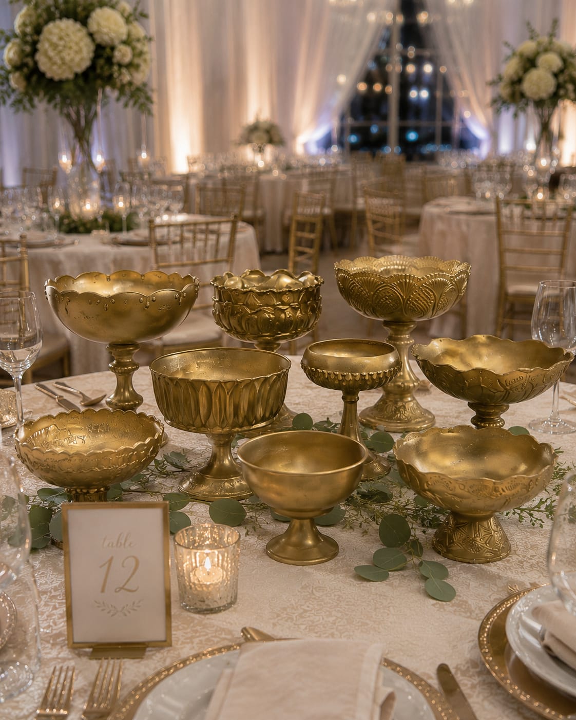 Caitlin Gold Compotes - Luxury doesn’t have to be complicated. The Caitlin Compote Collection instantly transforms ordinary reception tables into stunning focal points filled with warmth, elegance, and unforgettable style.  Featuring an eclectic collection of gold compotes in a variety of sizes, shapes, and heights, these versatile pieces bring the layered, professionally styled look seen in upscale weddings, bridal magazines, and luxury event venues. Whether filled with lush florals, romantic candlelight, greenery, seasonal accents, or custom centerpieces, the Caitlin Compote Collection creates depth, texture, and visual interest throughout your celebration.  From romantic garden weddings and rustic barn receptions to elegant ballroom celebrations and timeless classic events, these beautiful gold compotes complement virtually any wedding style while helping tie your entire design together. Their rich gold finish adds warmth and sophistication, creating the kind of atmosphere guests notice the moment they enter the room.  Part of the Aspen Attic Wedding &amp; Event Rental Collection, the Caitlin Compote Collection pairs beautifully with our cylinders, hurricanes, lanterns, candle holders, arches, and floral designs to create a cohesive and unforgettable event experience.  Available for weddings and events throughout Indianapolis, Cincinnati, Louisville, Greensburg, Batesville, Shelbyville, Rushville, Columbus, Franklin, and surrounding communities.