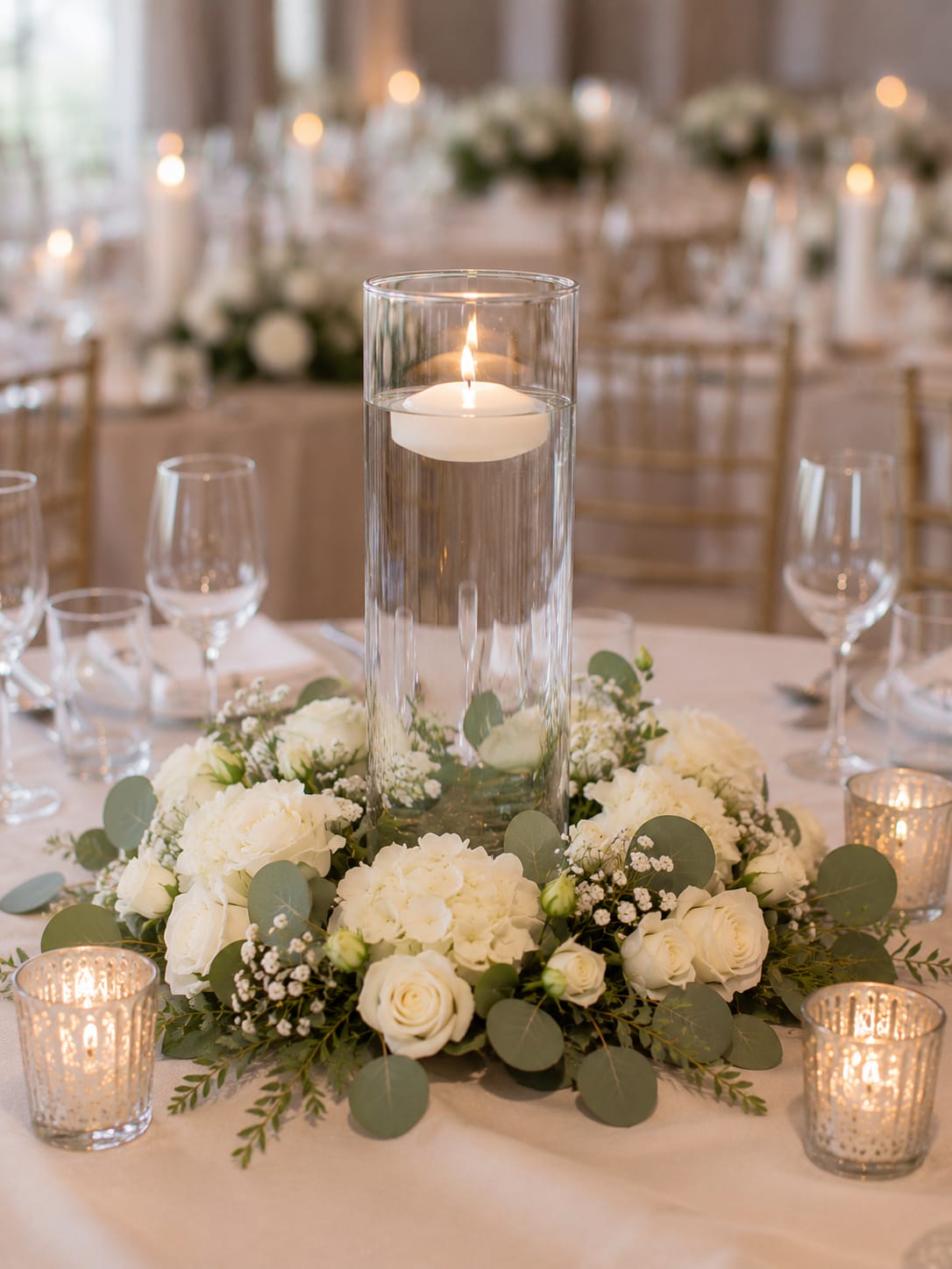 The Marissa Vase - The Marissa Cylinder Vase doesn’t rely on ornate details, decorative patterns, or complicated design elements to earn its place on the table. Its appeal comes from proportion, clarity, and balance. The smooth, uninterrupted lines create a clean visual presence that feels polished, intentional, and refined.  Crystal-clear glass has a unique ability to reflect light, add dimension, and create an elevated look without adding visual clutter. That’s what makes a cylinder vase one of the most enduring and versatile pieces in event design. It feels elegant without trying too hard.  The Marissa Vase is equally at home in a formal ballroom, an industrial loft, a garden celebration, or an intimate gathering. It blends seamlessly into its surroundings while still contributing to the overall atmosphere of the room.