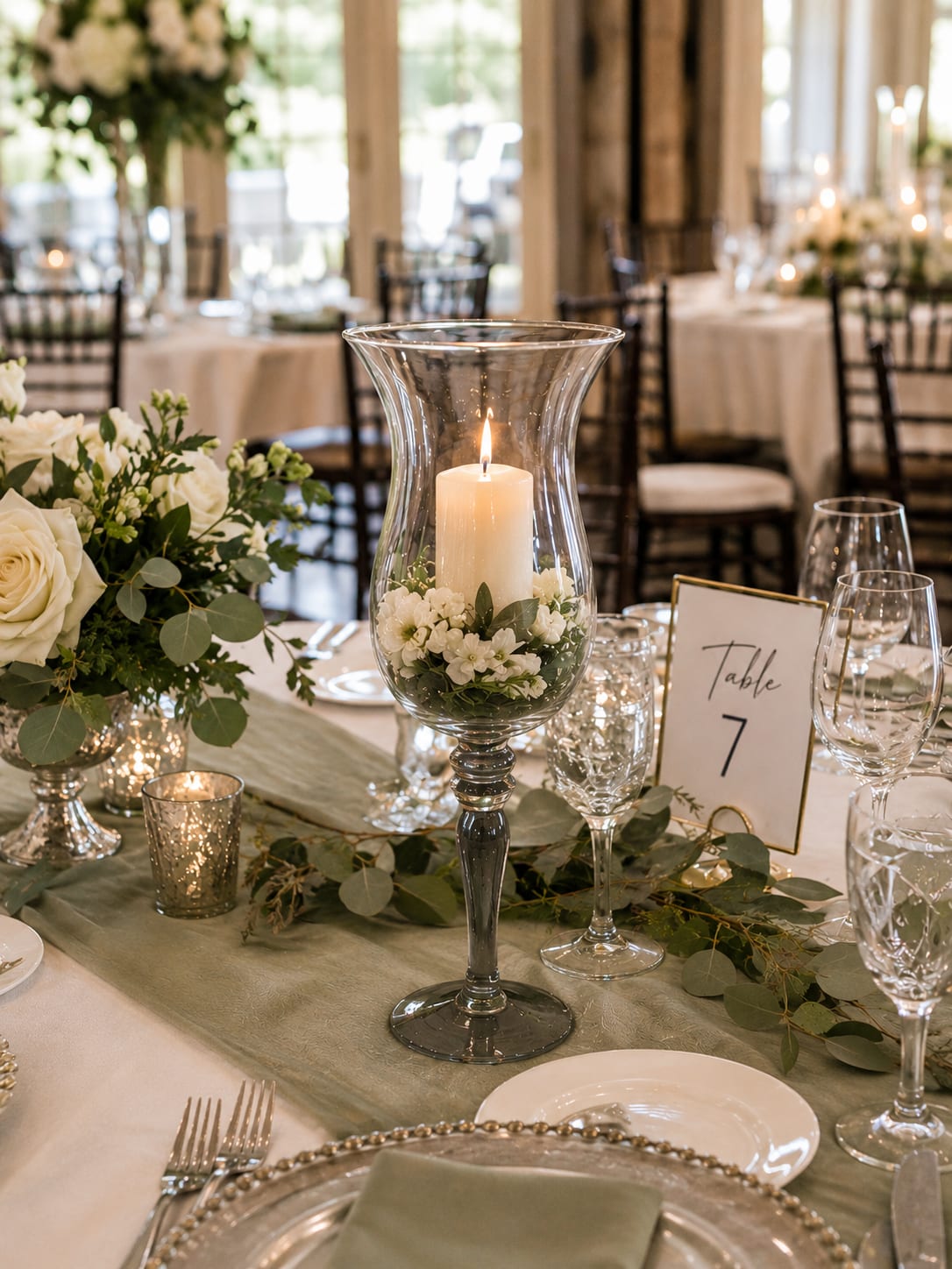Hannah Stem Vase - As the medium vase in our pedestal stem collection, the Hannah Vase brings balance to your design. It’s large enough to make a statement, yet refined enough to let your flowers, candlelight, and personal style take center stage. Used alone, it creates a sophisticated focal point. Paired with the Hailey and Harmony vases, it creates the layered, custom-designed look often seen in high-end weddings and luxury events.  The magic isn’t in the vase itself. It’s in what happens when guests walk into the room and see a reception that feels intentional, coordinated, and beautifully finished. The Hannah Vase helps bridge the gap between simple décor and a truly memorable event, creating visual interest without clutter and sophistication without excess.  Whether filled with lush florals, glowing candlelight, seasonal accents, or elegant greenery, the Hannah Vase helps transform ordinary tables into gathering spaces where memories are made, photographs are taken, and celebrations unfold.