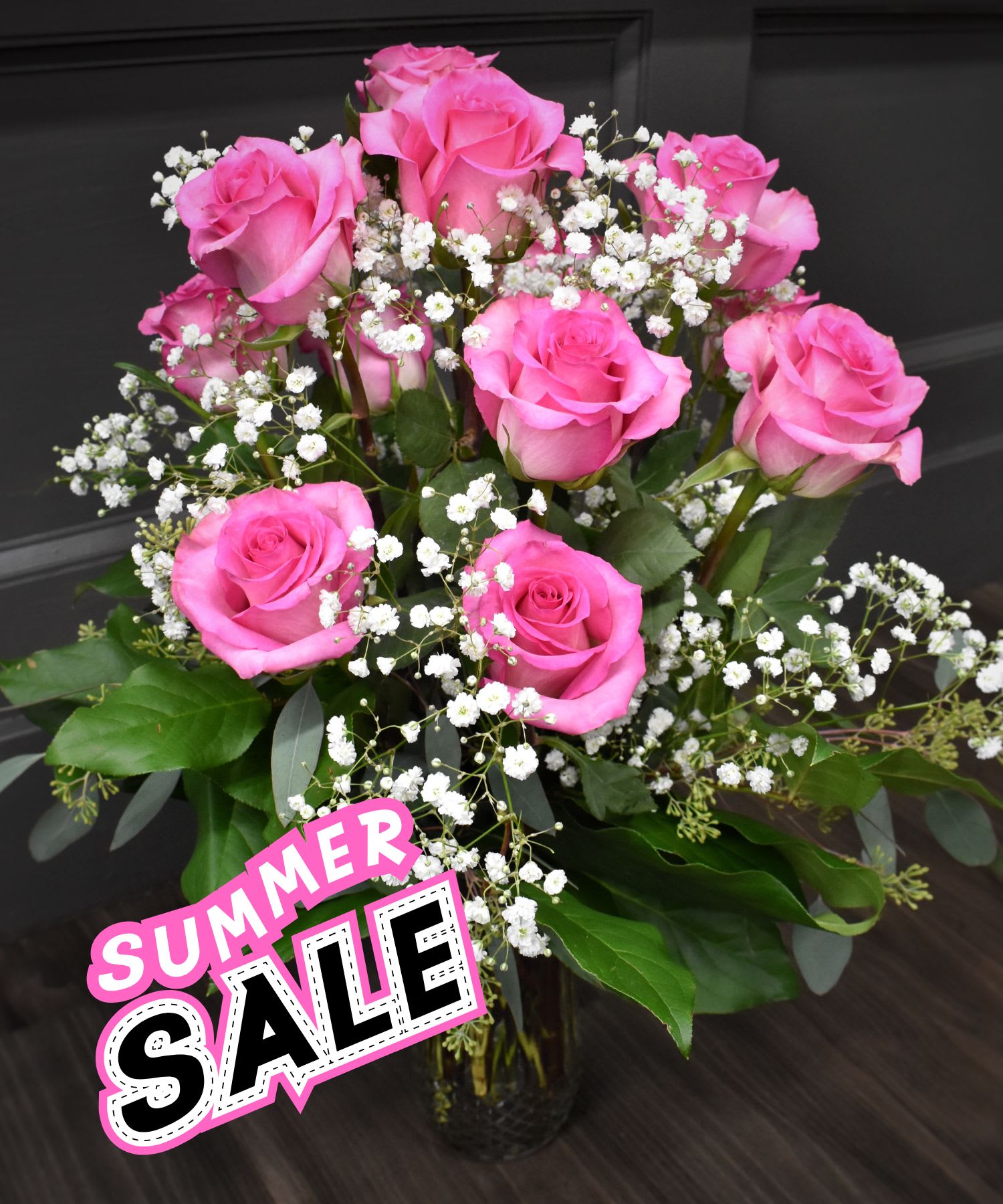 Pink roses with white baby's breath in a glass vase