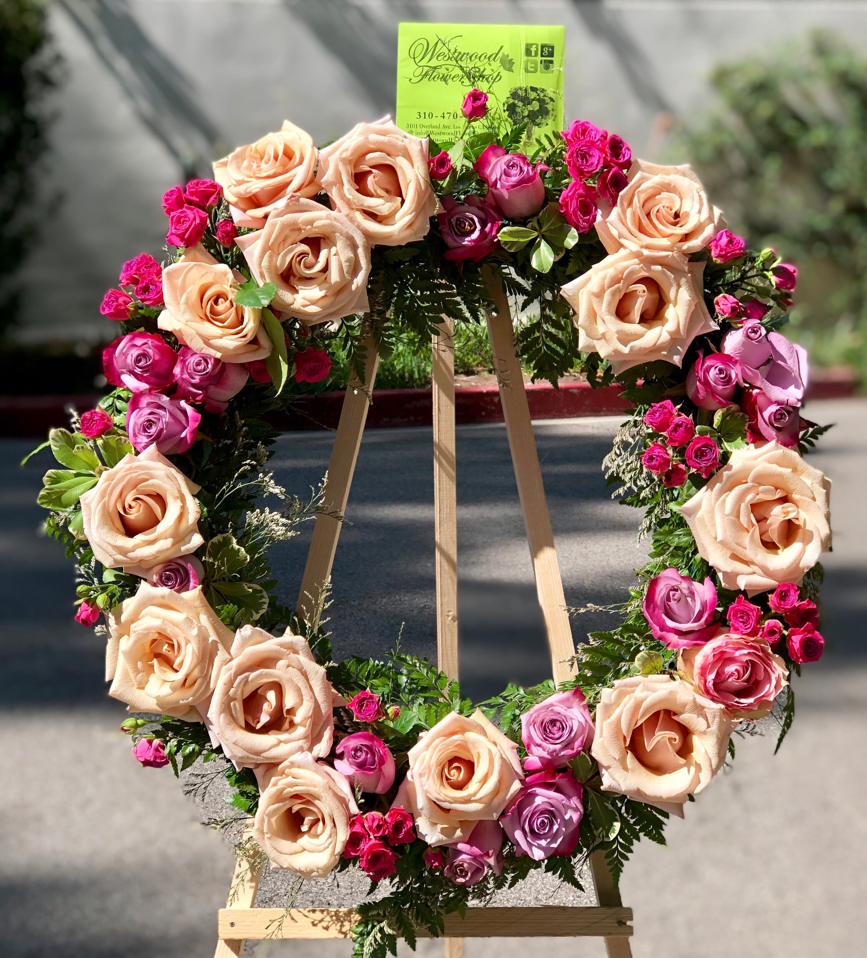 Heart-shaped rose wreath on a wooden easel