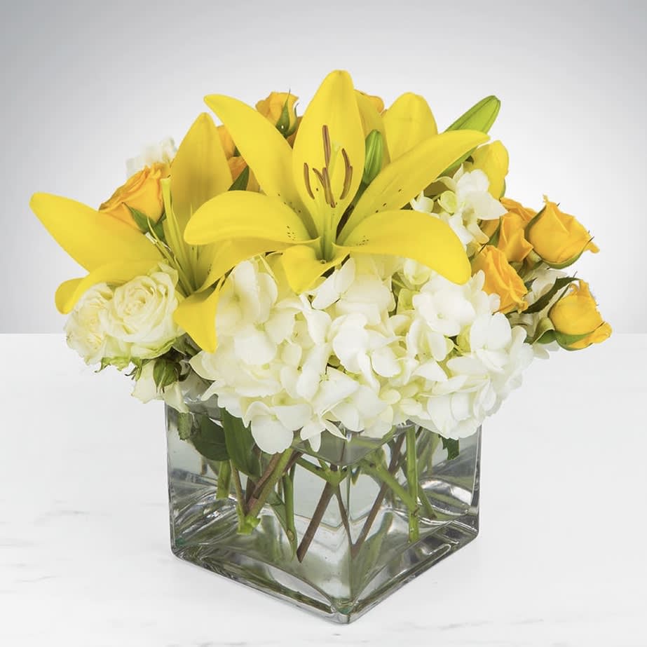 Kiss of the Sun - Bring the sunshine to someone's day with the gorgeous, roundy moundy cheerful bouquet. This bouquet designed with asiatic lilies, roses, spray roses, and hydrangea is the perfect gift for someone's birthday or to uplift someone's spirits. Order for same day delivery today!  Approximately 9" D