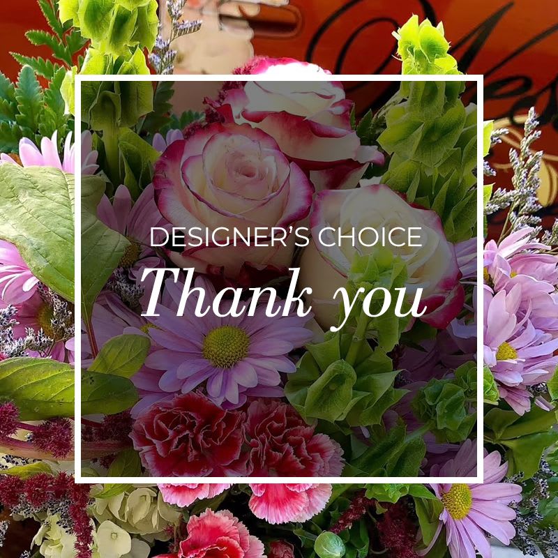 Mixed bouquet of pink roses, daisies, and carnations with green blooms