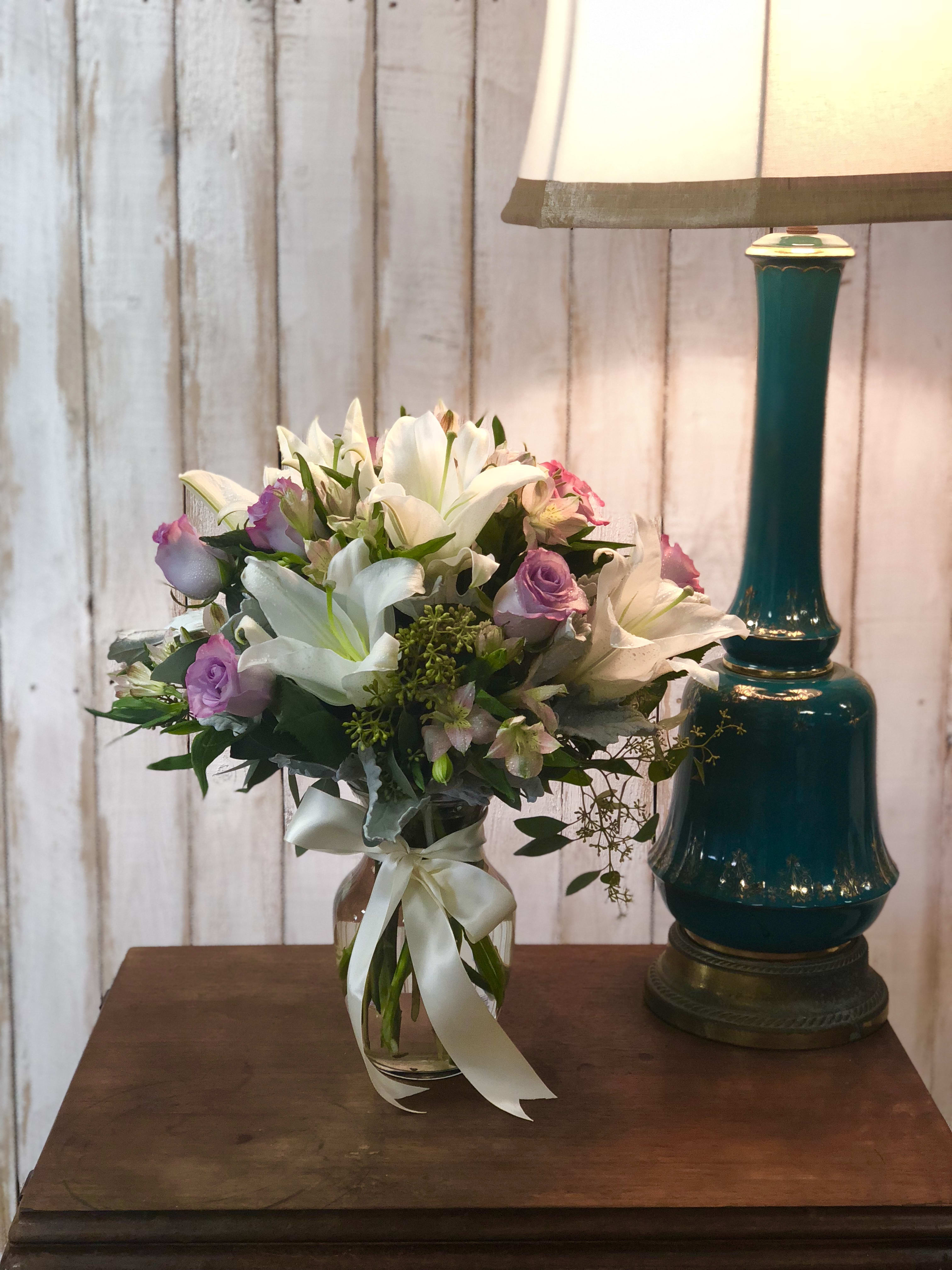 Lavender and Vanilla  - This white and lavender bouquet includes white lilies, lavender roses, alstroemeria, and eucalyptus. 