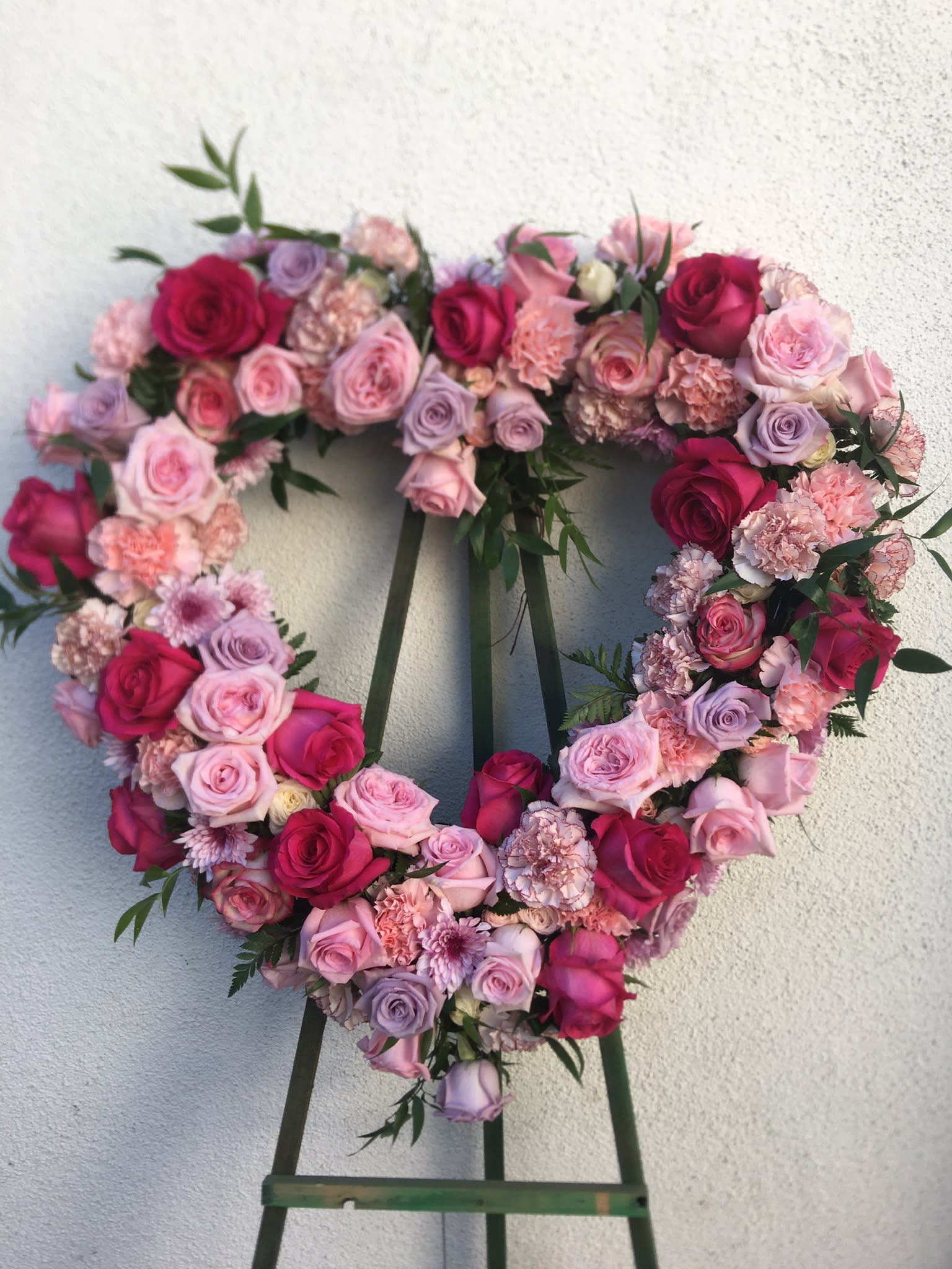 Love Forever  - Heart shaped spray is made with pink and lavender blooms. Can be made in other colors upon request.
