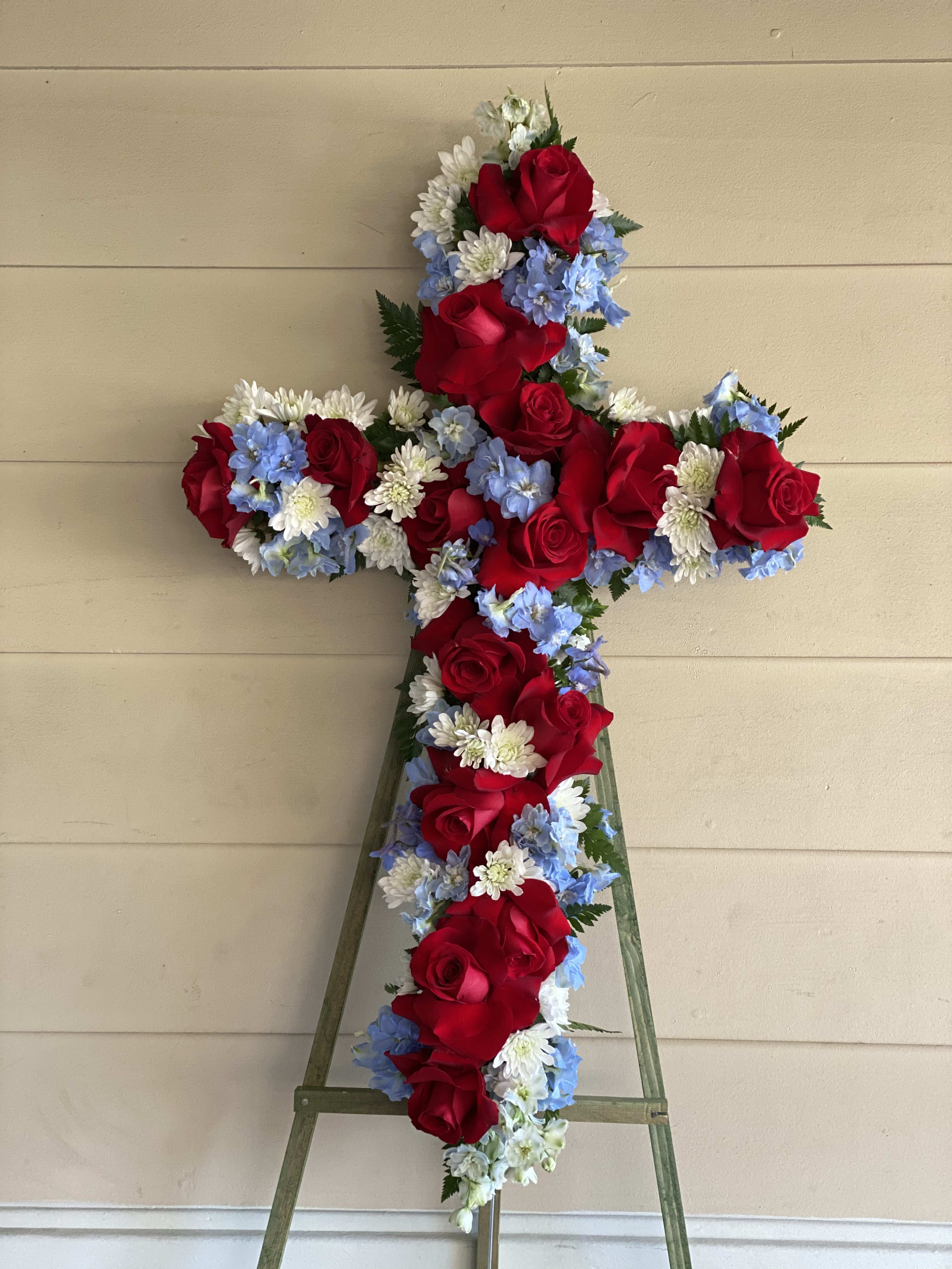 Thank You For Your Service  - This standing cross is a fine tribute for any patriot, showing red roses, blue delphinium and white mums.