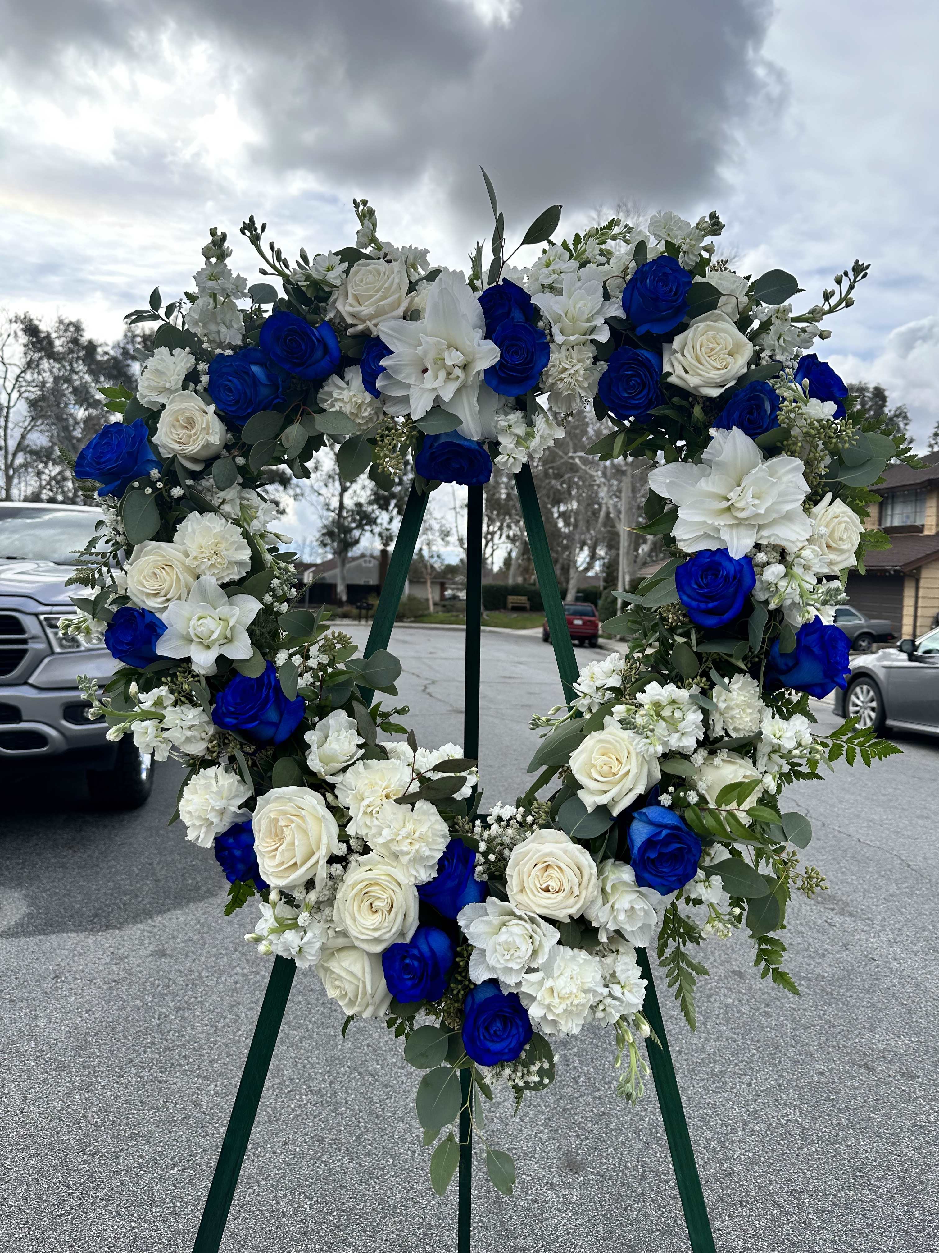 Blue and white floral wreath on a stand