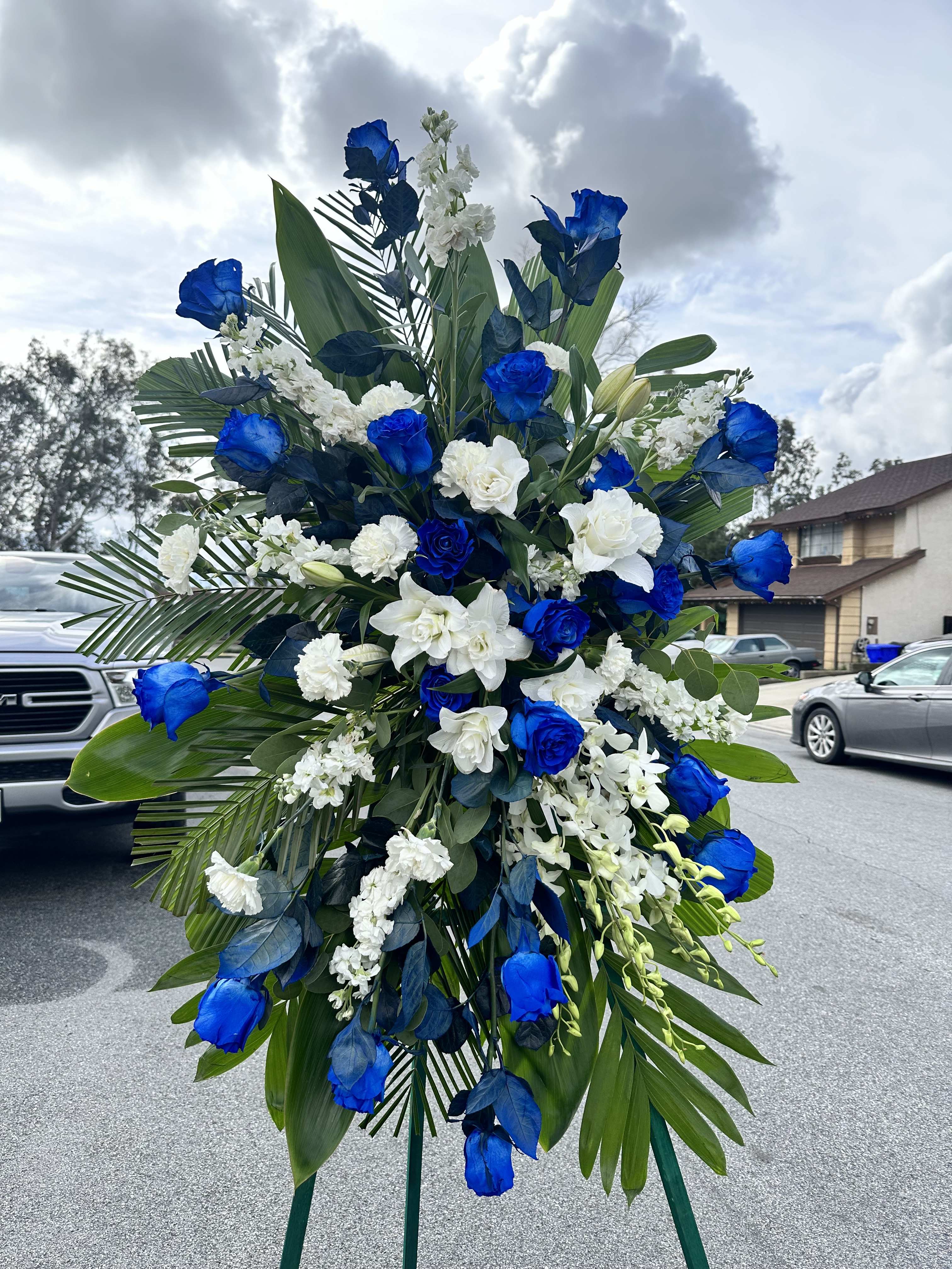 Serenity spray - Serenity spray consist of beautiful, deep blue roses carnations lilies chrysanthemum and stock