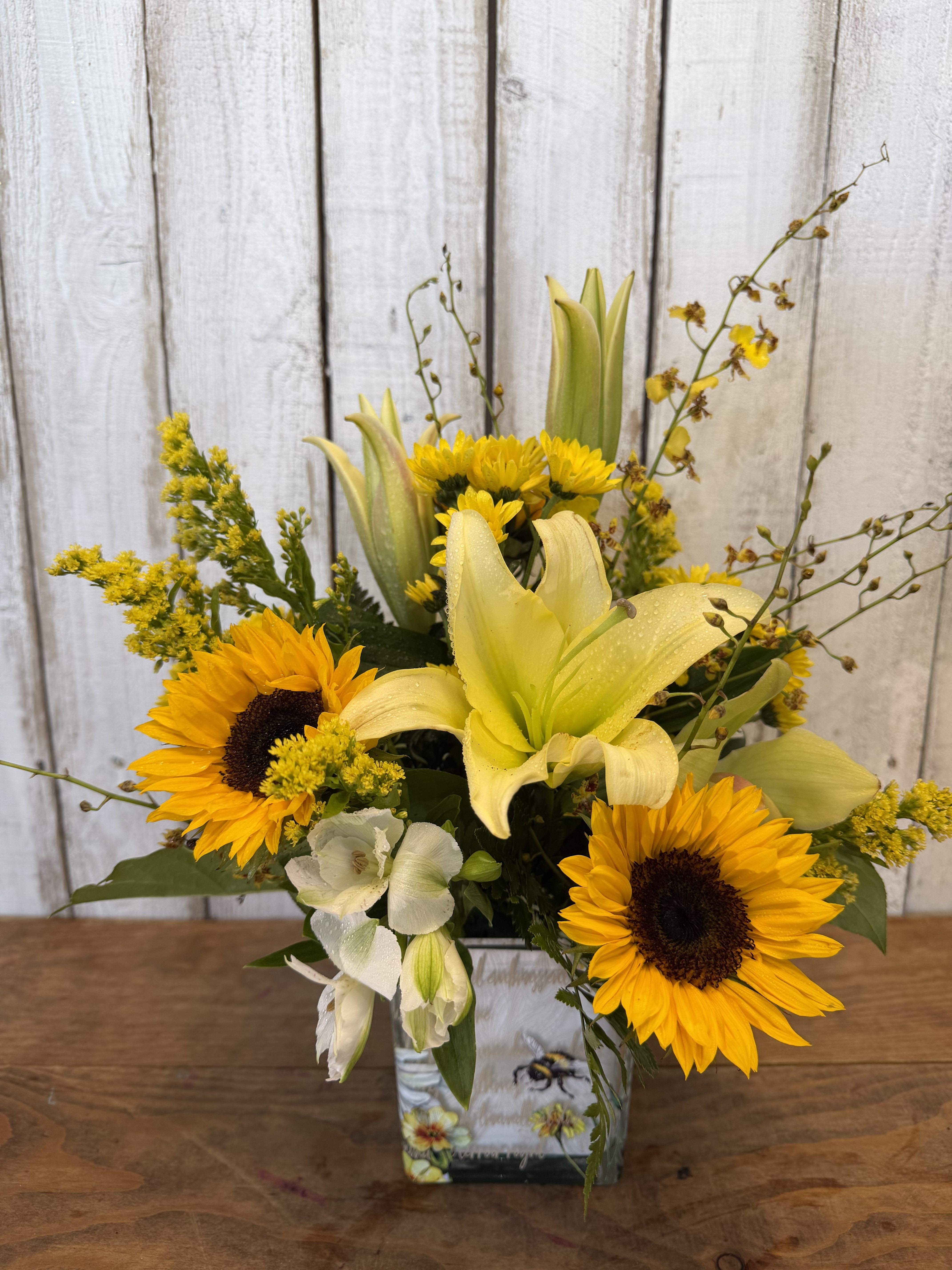 My little bumblebee - Bright yellow arrangement with sunflowers lilies, accent, yellow fillers designed in a bumblebee keeps a container so adorable ready for delivery or pick up here in Rancho Cucamonga