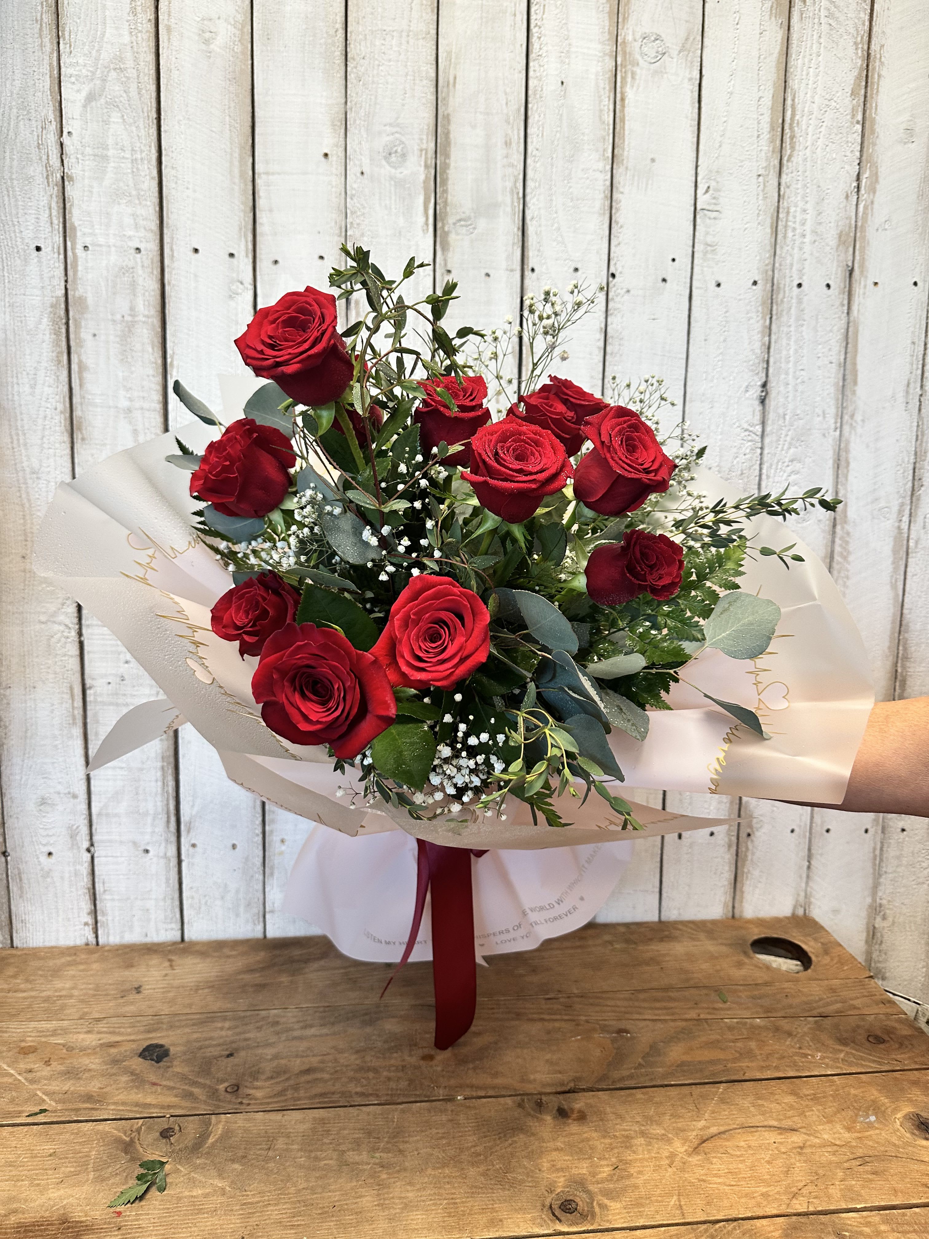  12 Fresh long stem Red Roses Wrapped -   One dozen long stand red roses wrapped in paper 