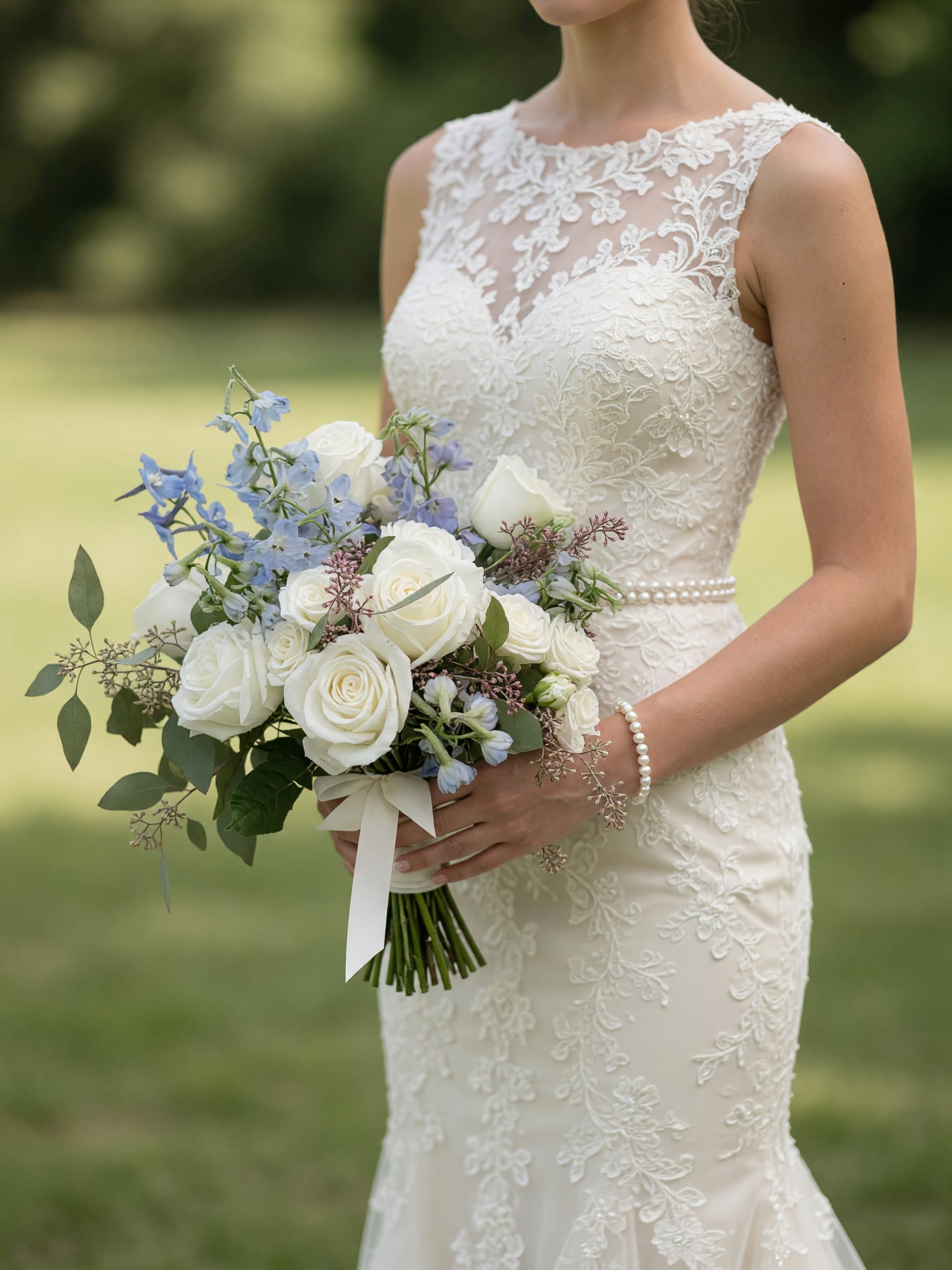 Something Blue Bridal Bouquet - Celebrate your wedding day with our timeless Something Blue Bridal Bouquet, a romantic hand-tied design featuring premium white roses, delicate blue delphinium, soft seasonal accents, and fresh eucalyptus greenery. Inspired by classic elegance and modern garden-style weddings, this bouquet offers the perfect blend of sophistication, texture, and charm.  The crisp white blooms symbolize purity and new beginnings, while the soft blue delphinium adds a touch of tradition and romance. Perfect for outdoor weddings, garden ceremonies, vineyard venues, and elegant ballroom celebrations.  Handcrafted by the floral designers at Tommy Austin Florist, each bouquet is designed using fresh, premium flowers and customized to complement your wedding style.  Features:  * Premium white roses * Soft blue delphinium * Fresh eucalyptus greenery * Garden-inspired bridal design * Hand-tied with satin ribbon * Perfect for classic, romantic, and elegant weddings