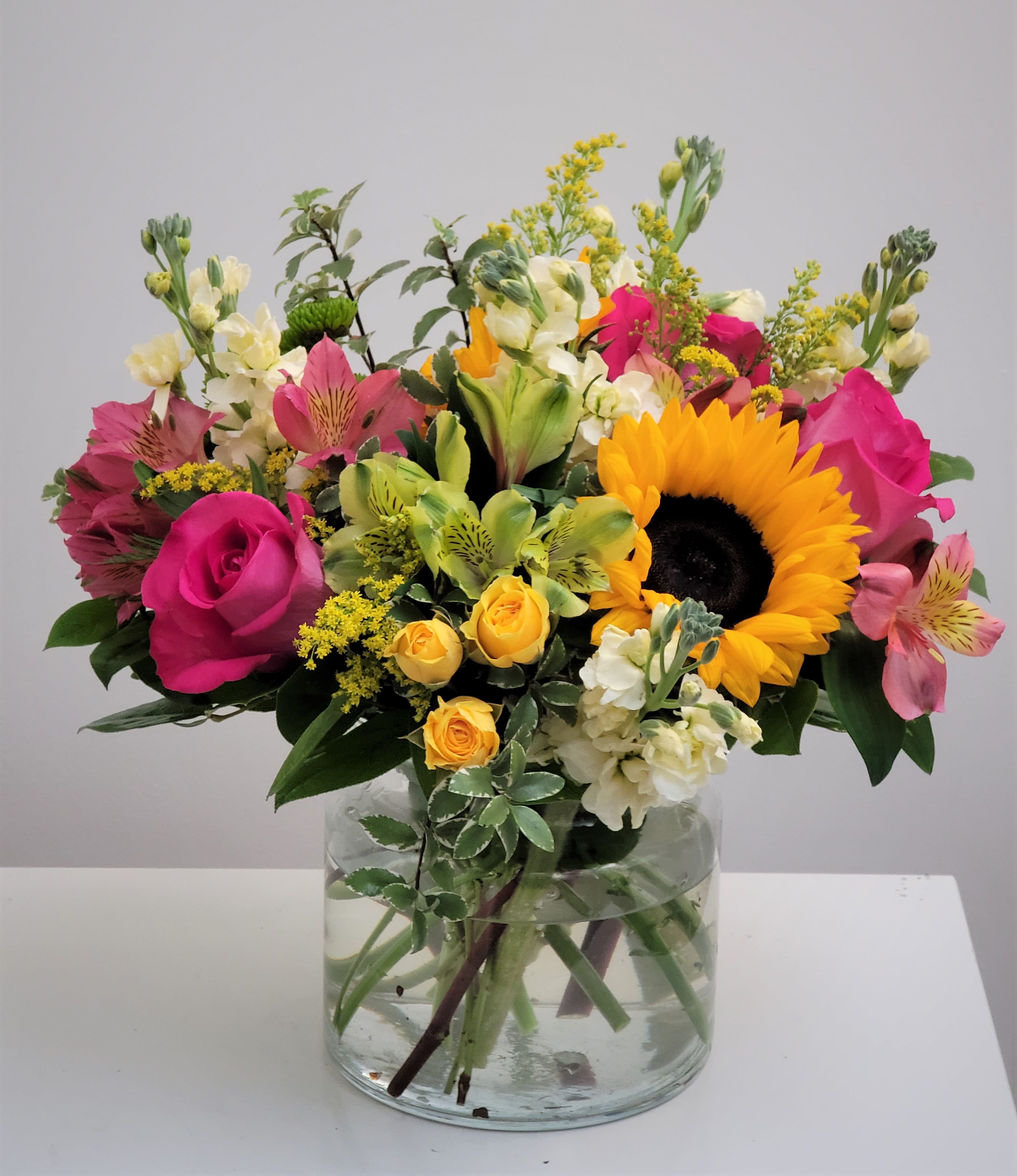 Best Day Flower Bouquet  - Make their day unforgettable with a radiant mix of sunflowers, pink roses, and seasonal accents.   Expertly arranged in a classic clear glass vase, this vibrant bouquet is perfect for birthdays, anniversaries, or simply sharing joy. A true celebration in bloom!  Approximate Size: 15" H x 15" W. Order now for fresh flower delivery!