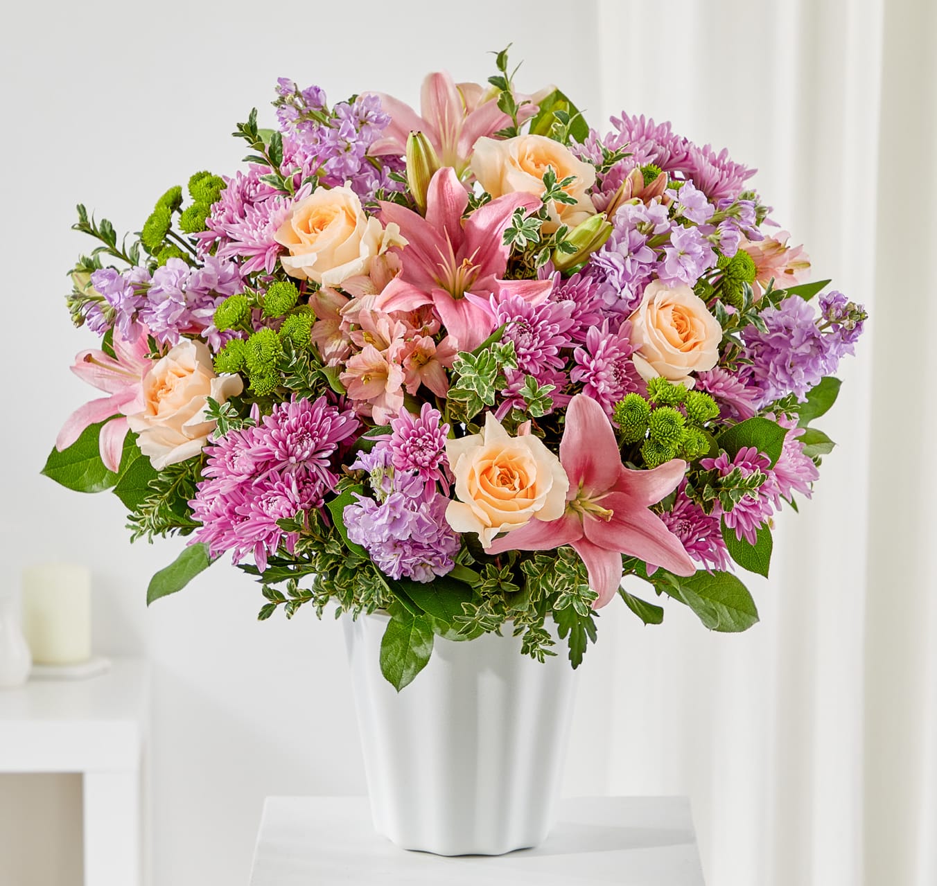 Pink and peach bouquet in a white vase