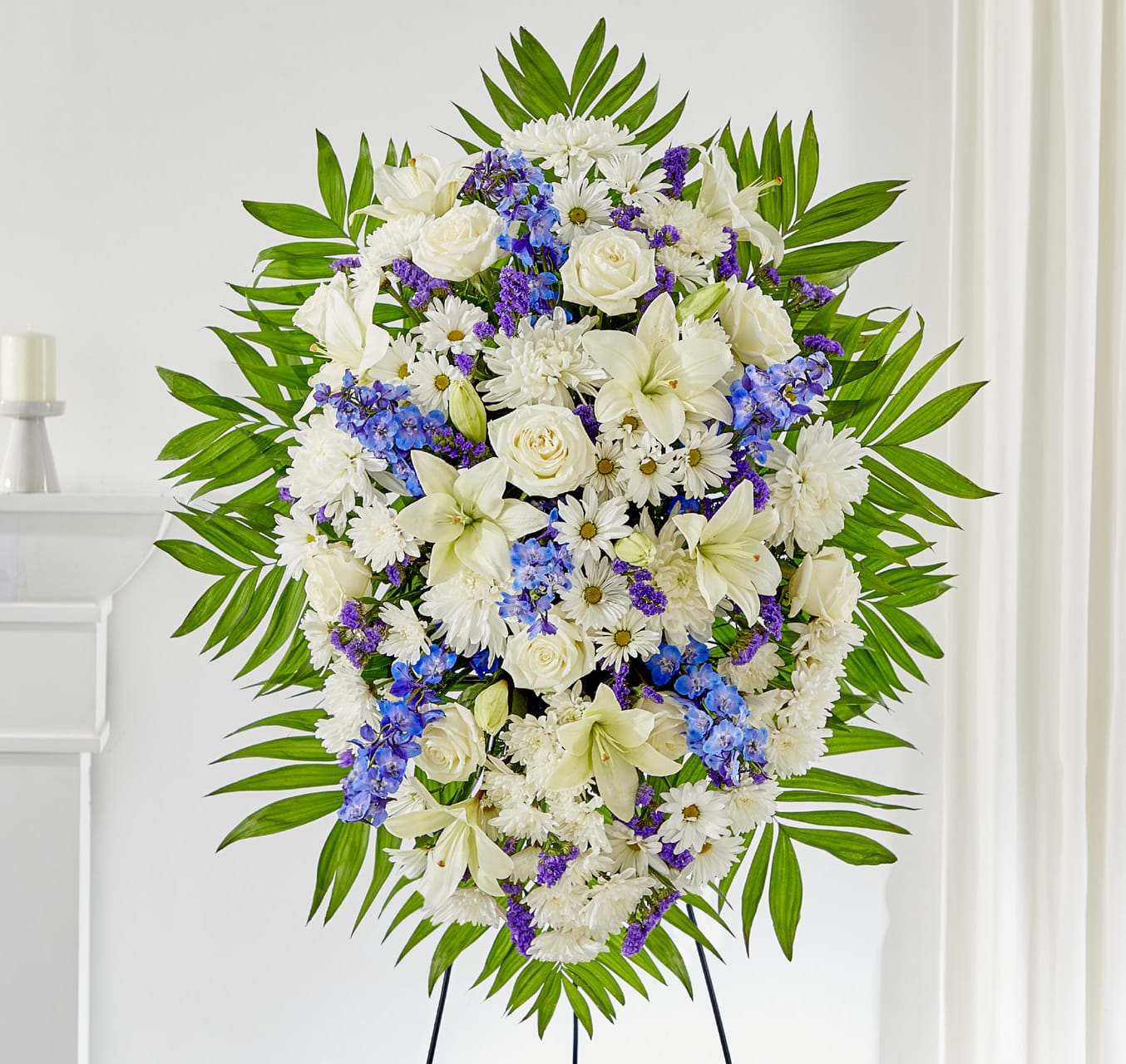 Standing floral spray of white flowers with blue and purple accents
