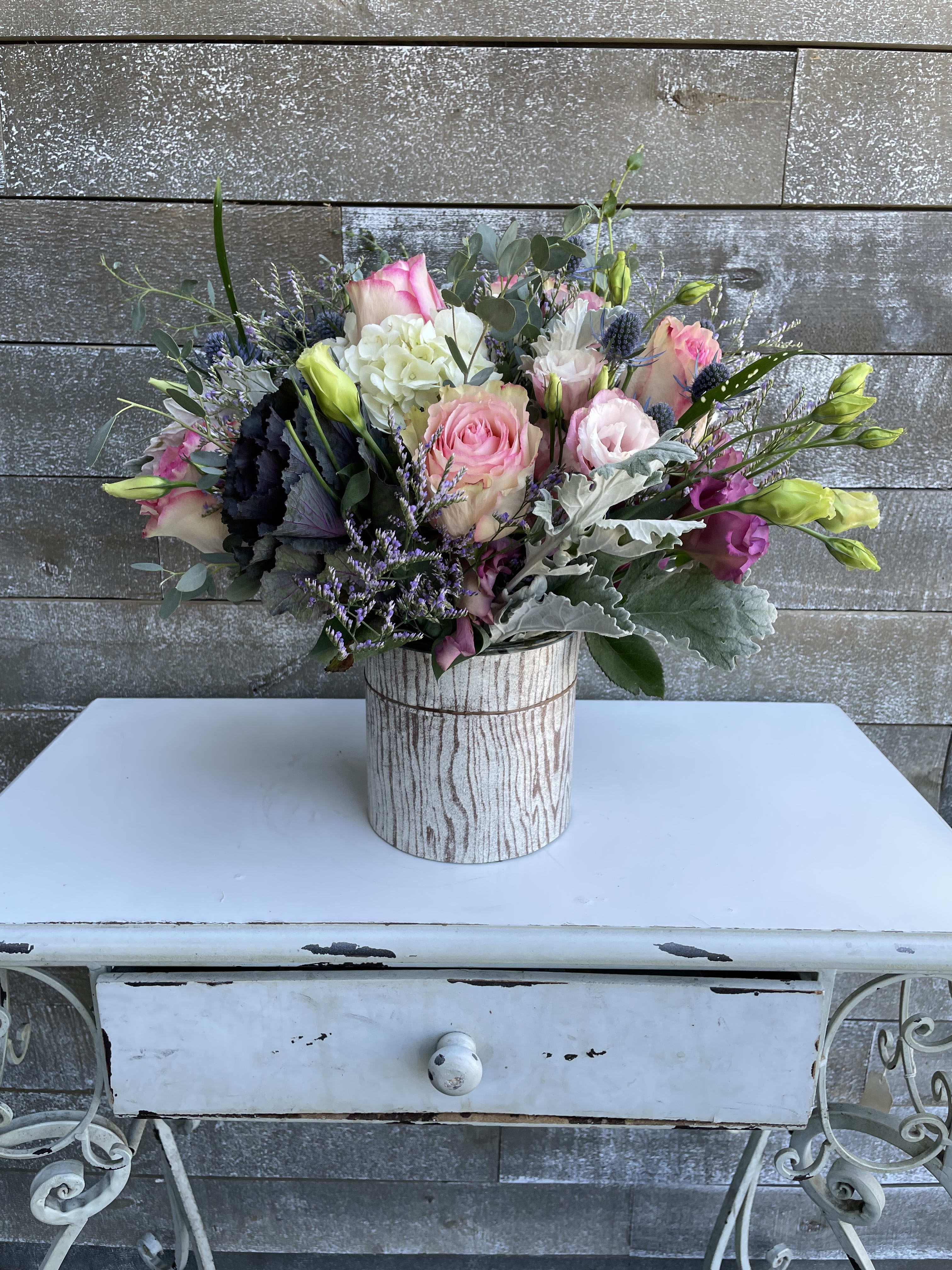 Mixed pink and white bouquet in a rustic wood-look container