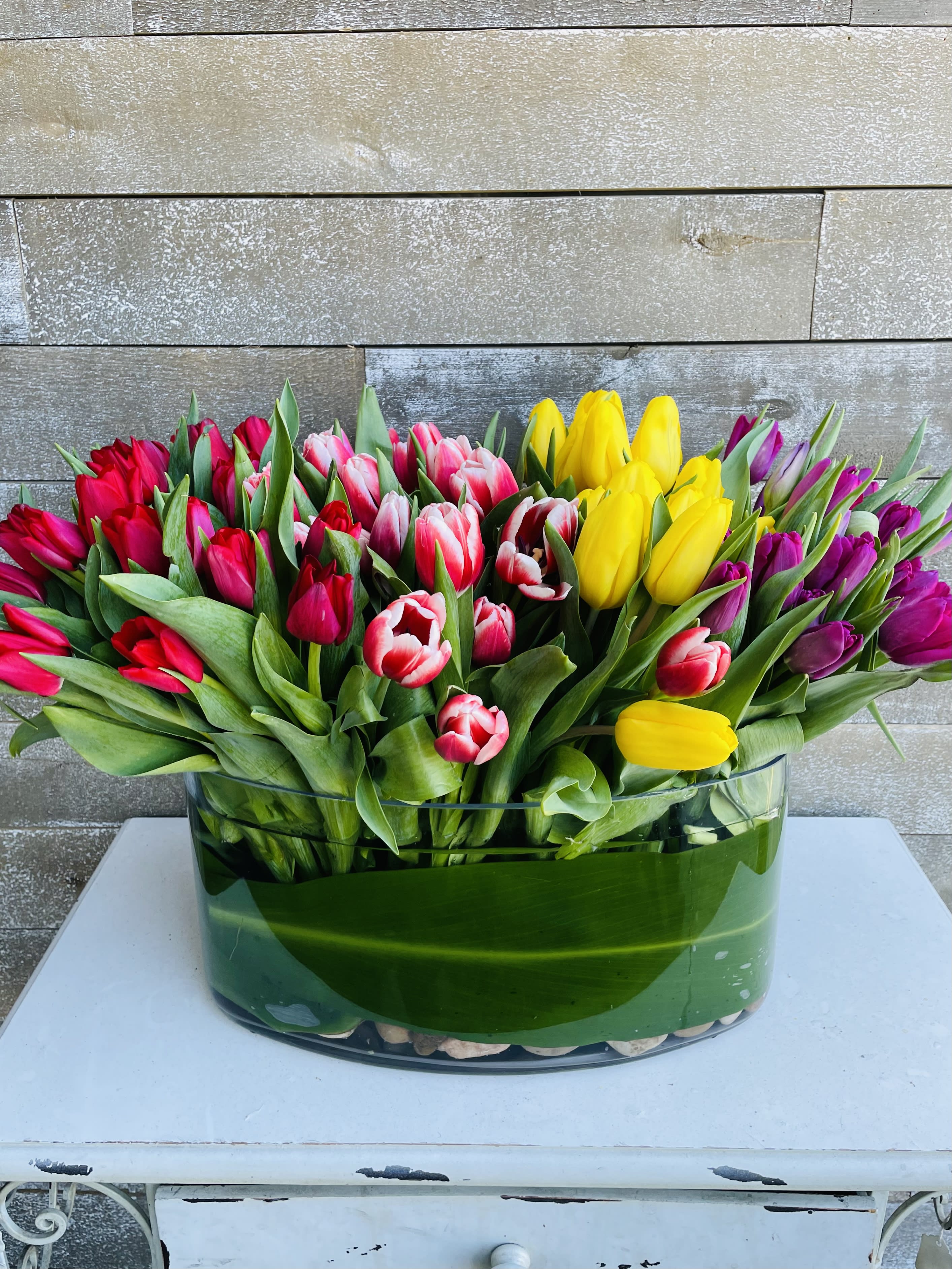 Colorful tulip arrangement in a clear glass vase