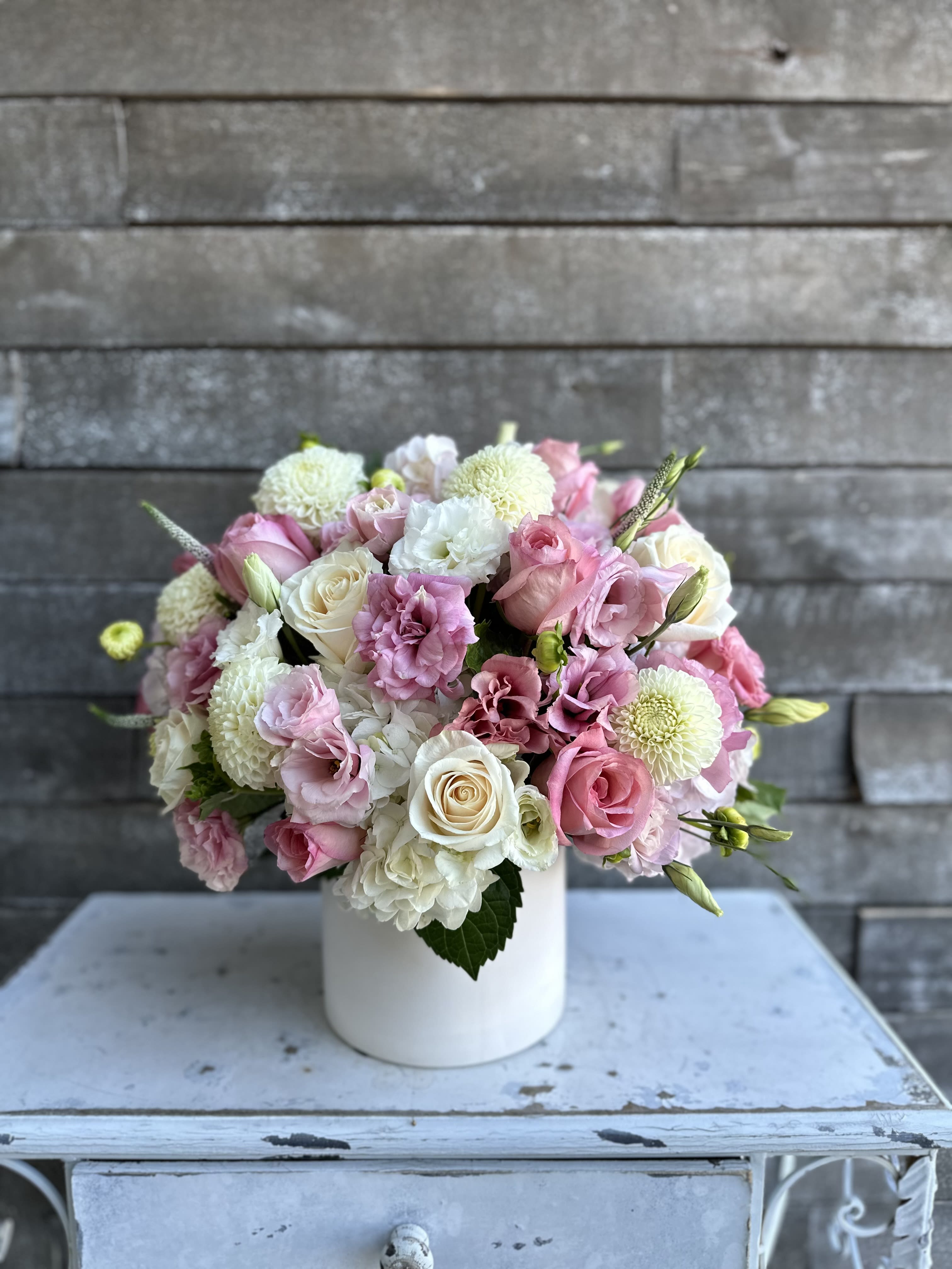 Pink and white bouquet in a white vase