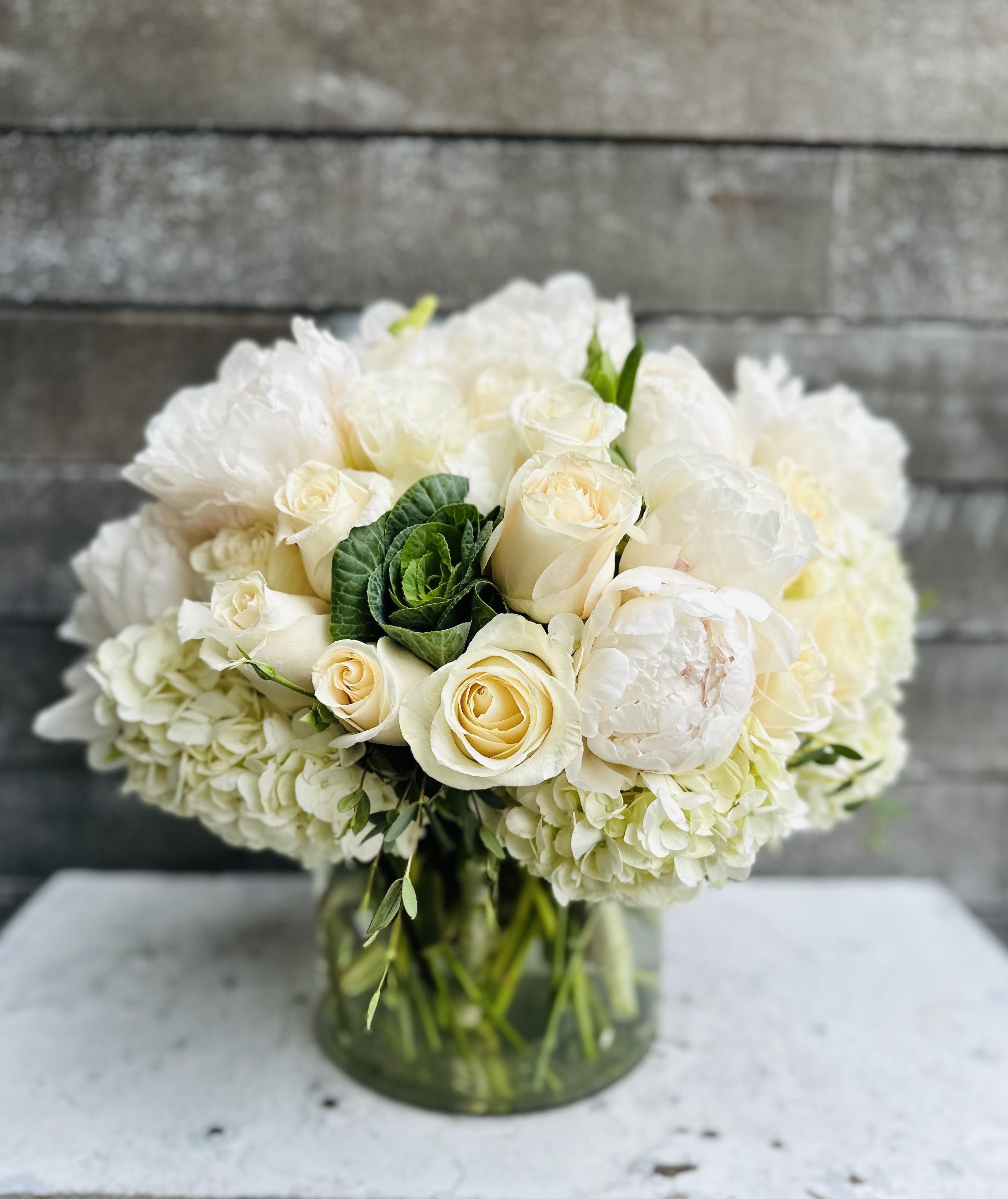 White rose and hydrangea bouquet in a glass vase