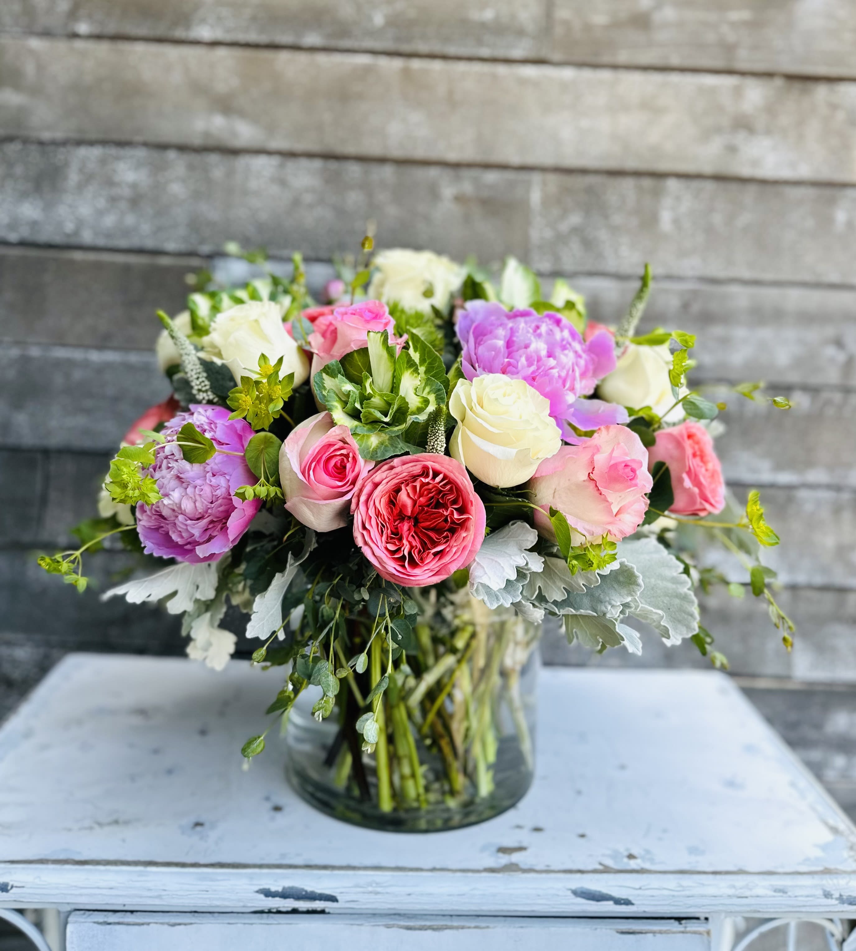 Mixed pink and white roses in a glass vase