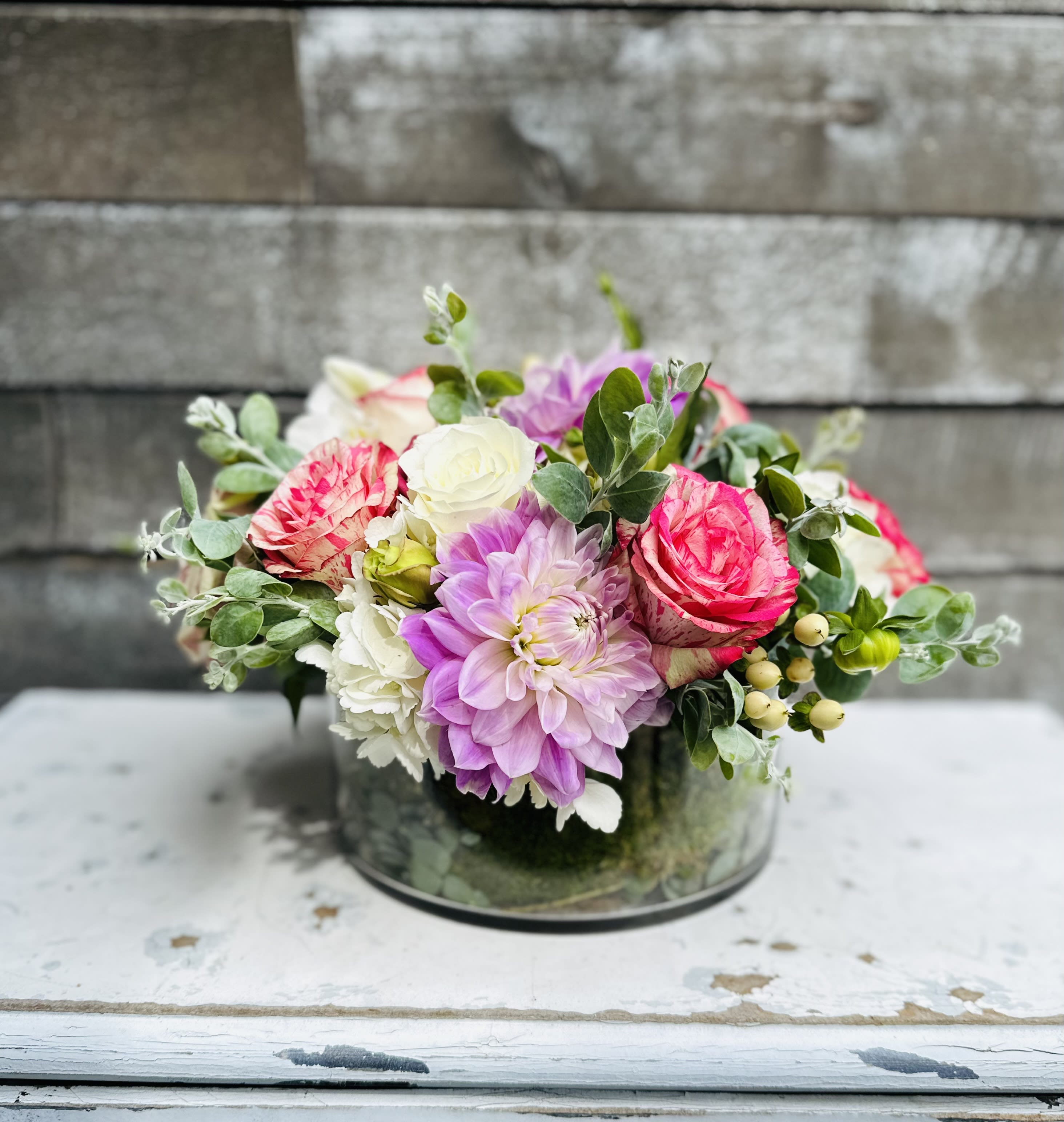 Pink and white mixed flower arrangement in a glass vase