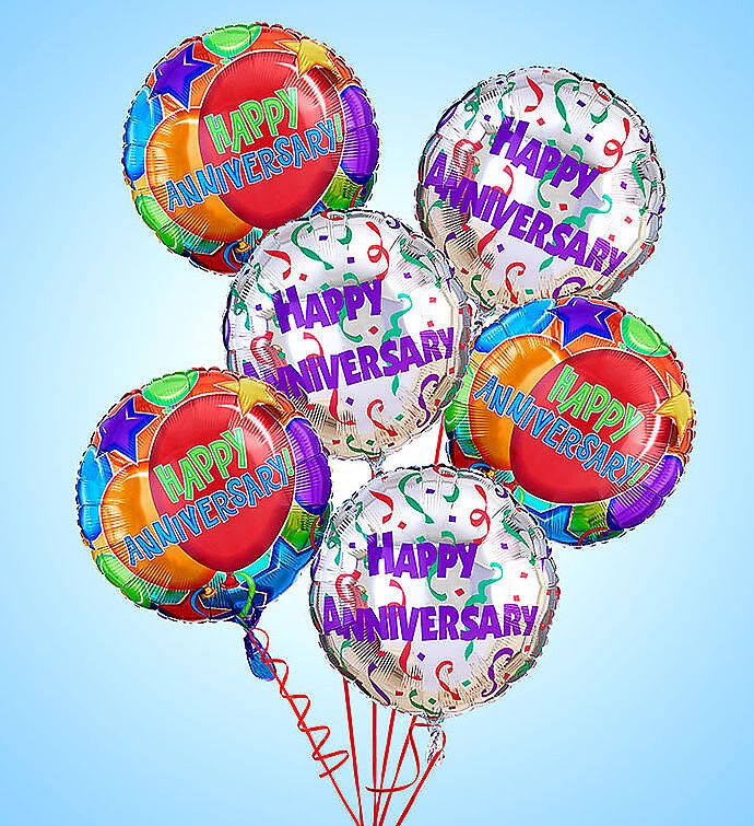 Cluster of colorful happy anniversary balloons on strings