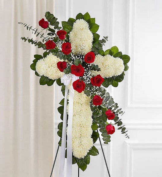 Cross-shaped floral spray with white chrysanthemums and red roses