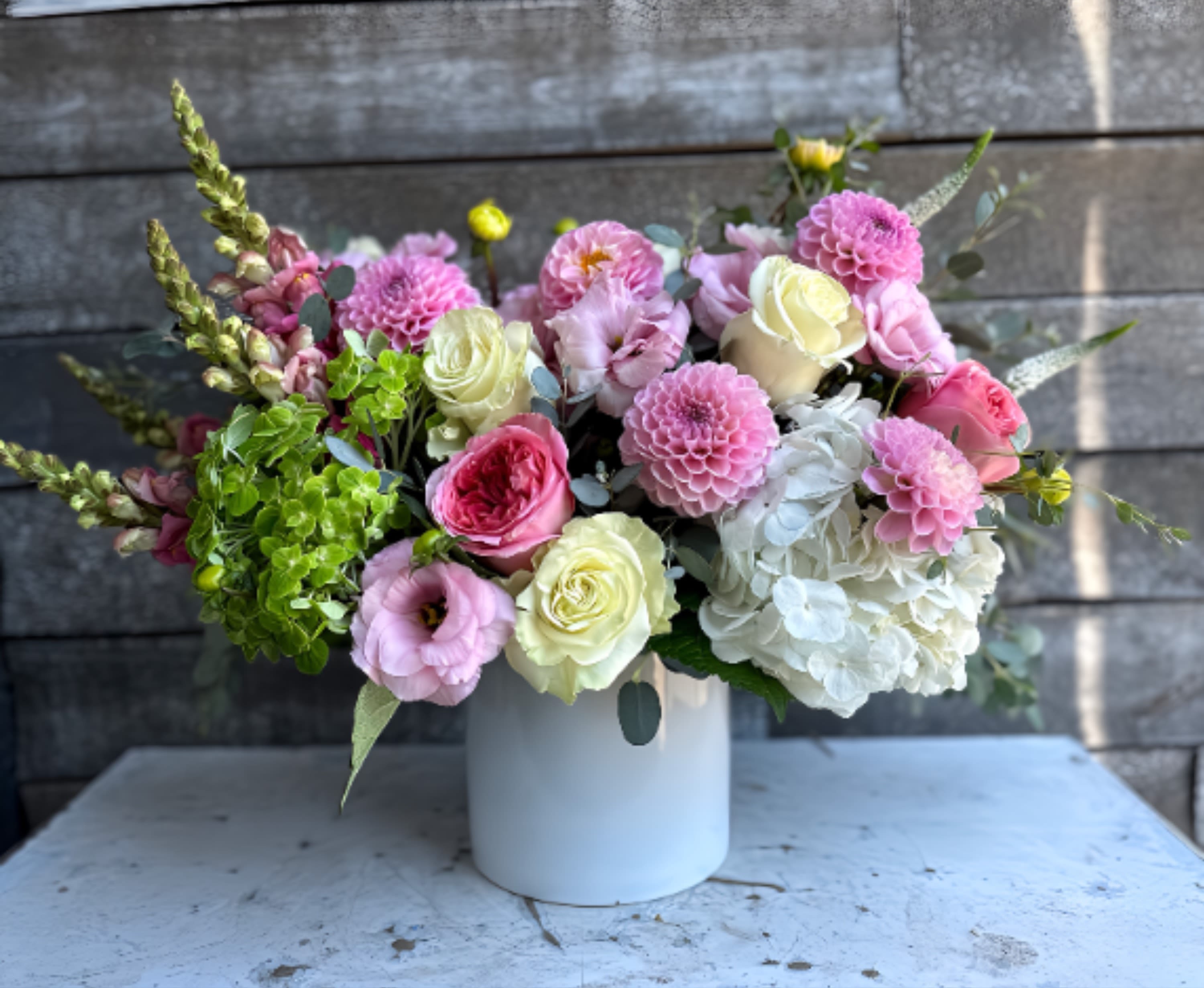 Pink and white mixed bouquet in a white vase