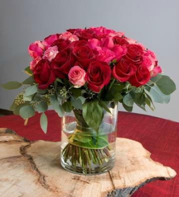 Bouquet of red and pink roses in a clear glass vase