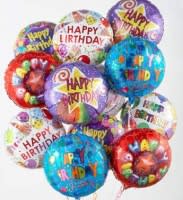 Cluster of colorful birthday balloons with printed messages