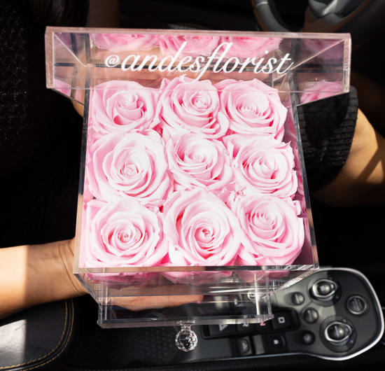 Pink roses arranged in a clear acrylic box