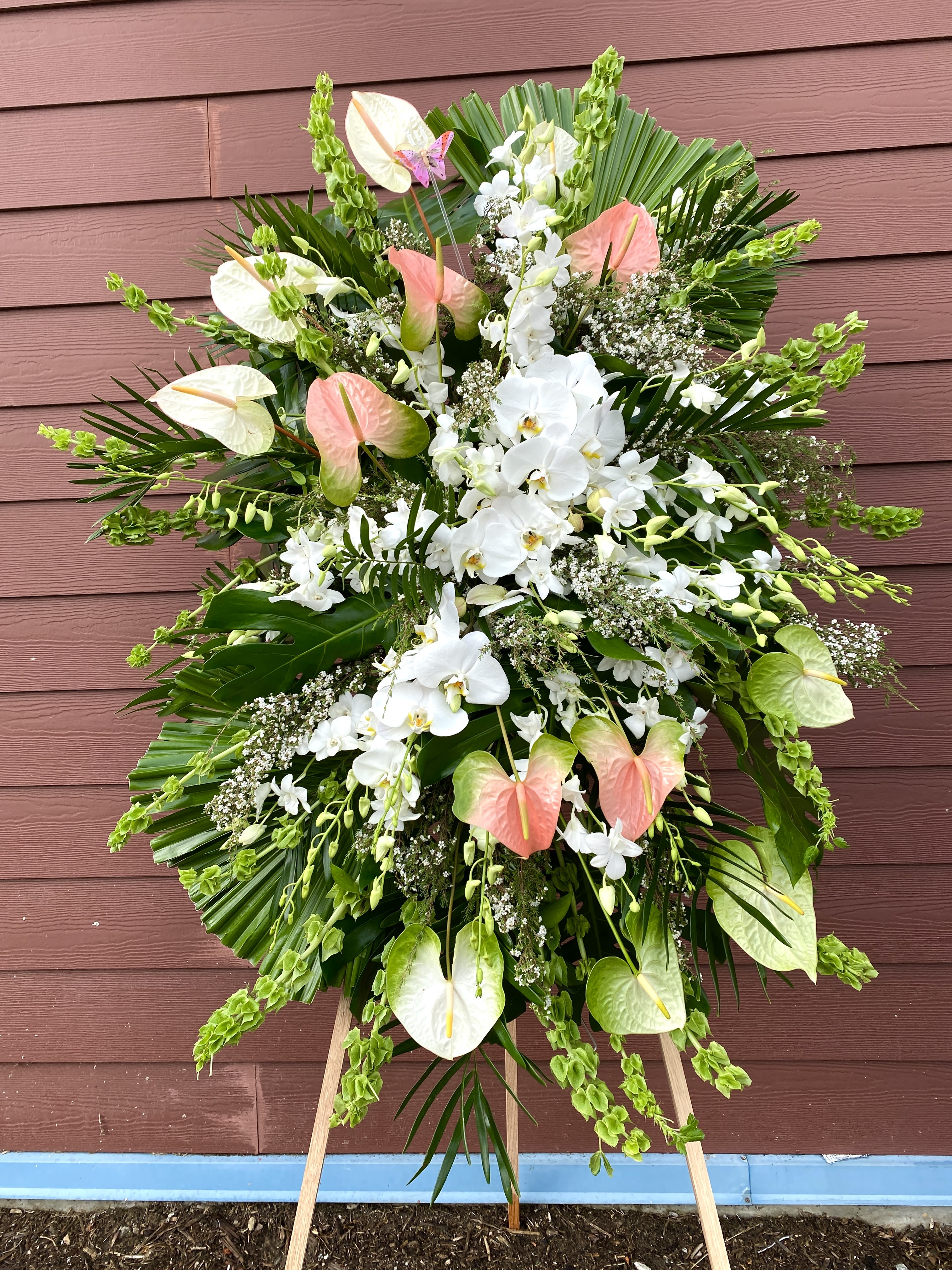 Large standing floral spray with white orchids and pink anthuriums