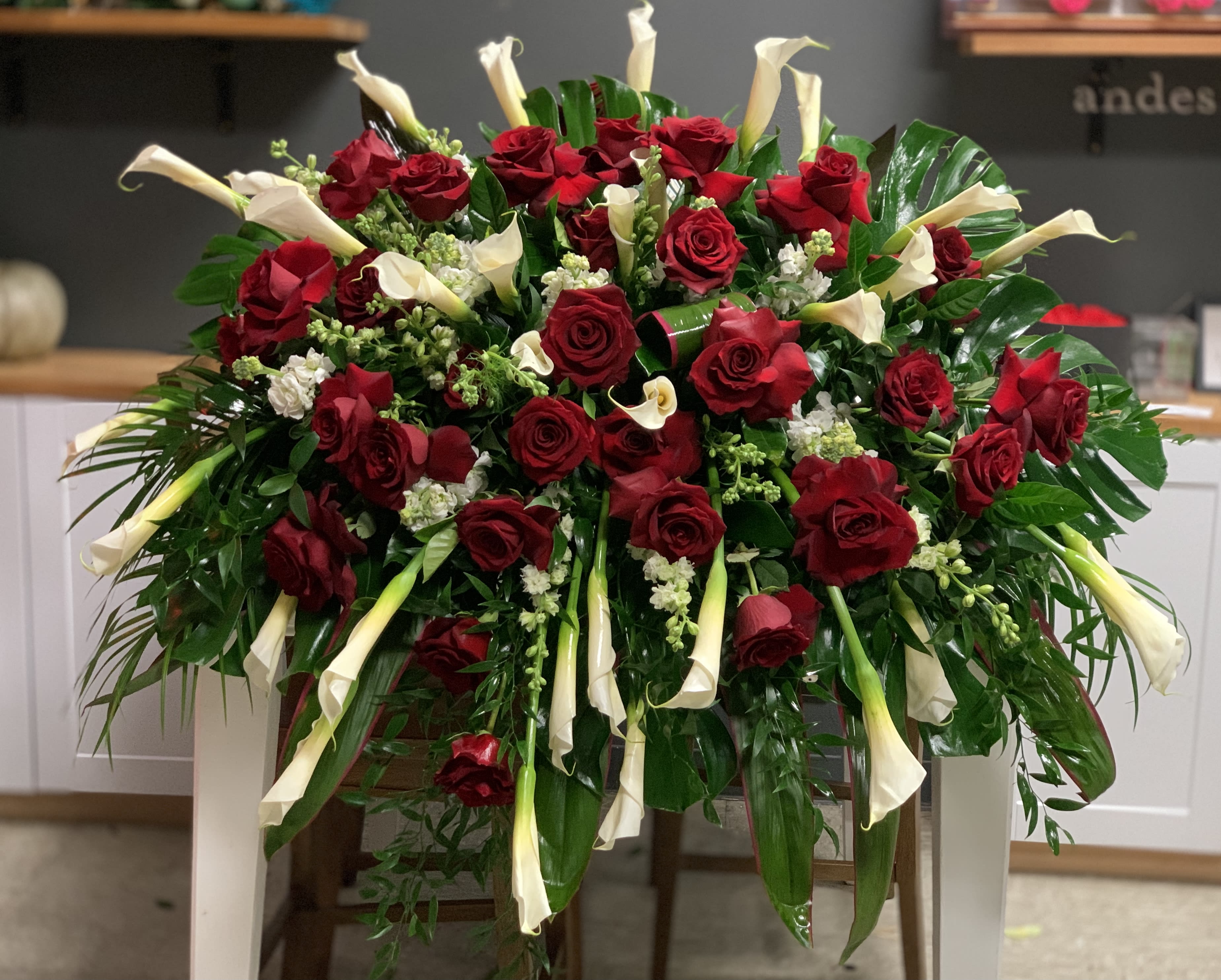 Large arrangement of red roses and white calla lilies