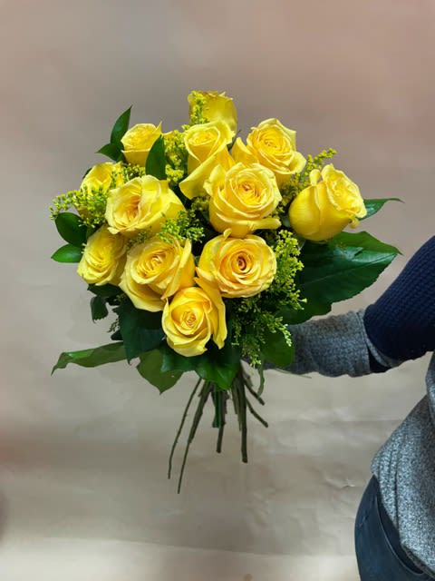 Bouquet of yellow roses with green filler and leaves