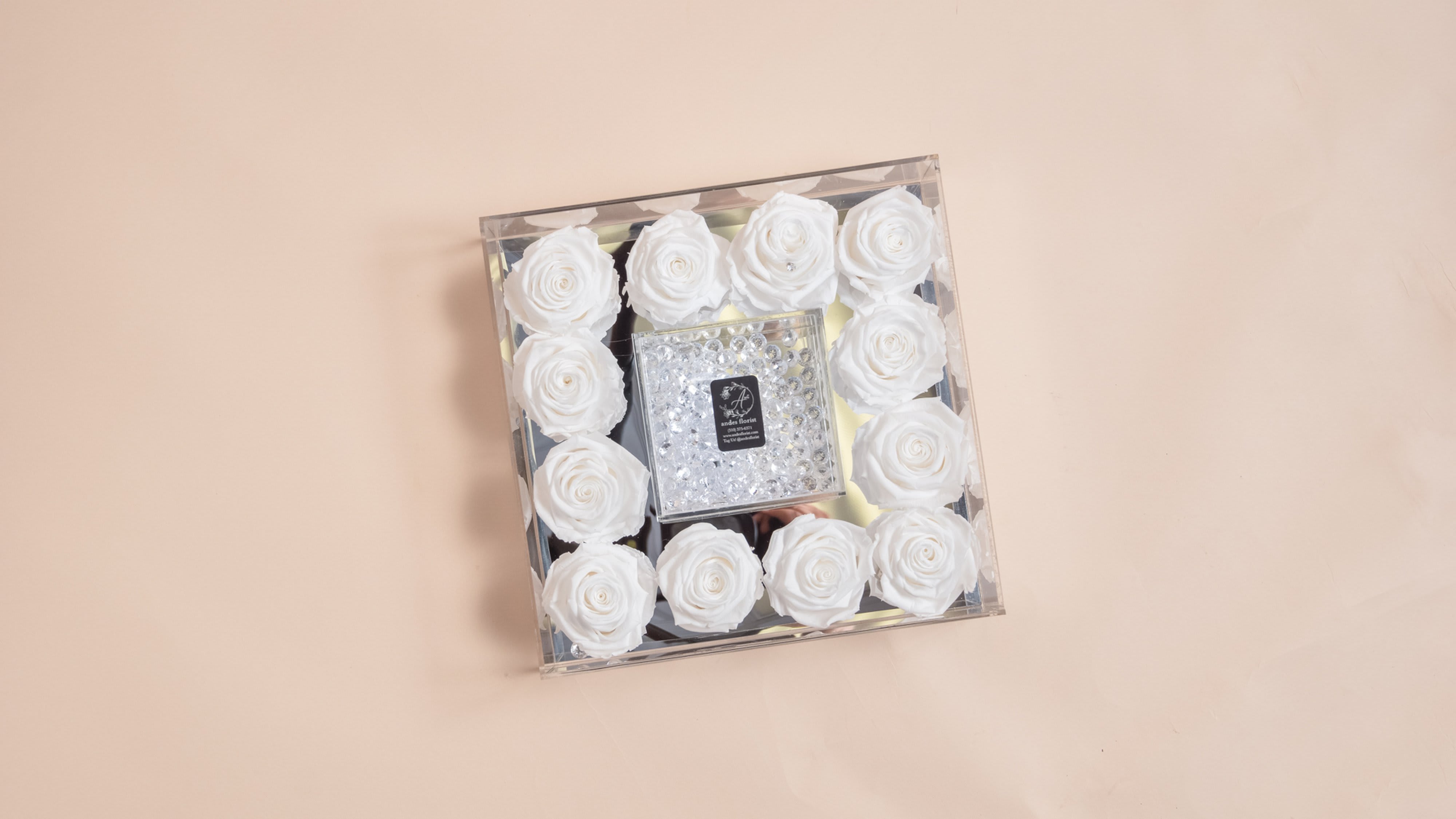 Square box of white roses with a clear jeweled center
