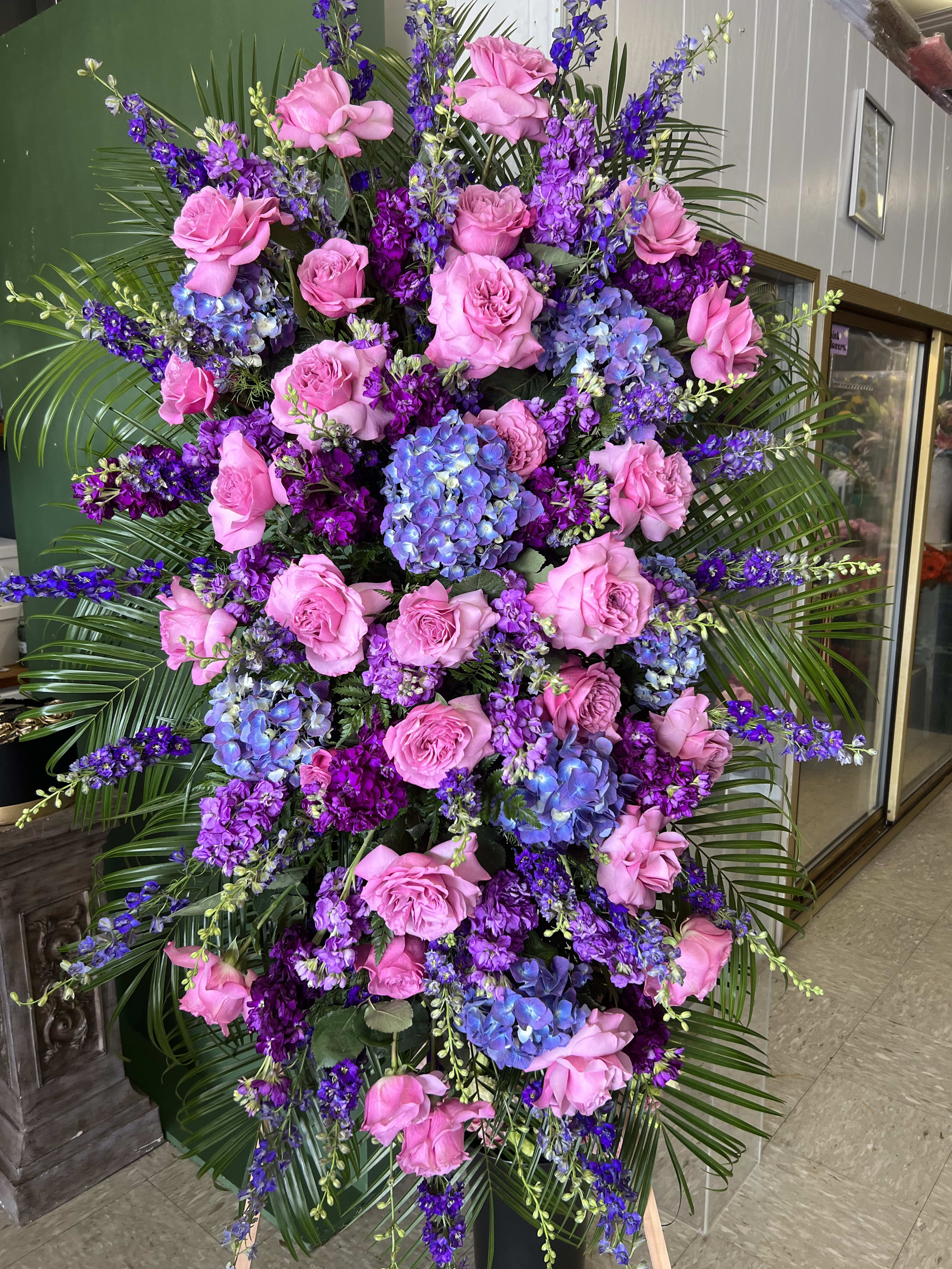 Large standing floral spray with pink roses and purple-blue hydrangeas